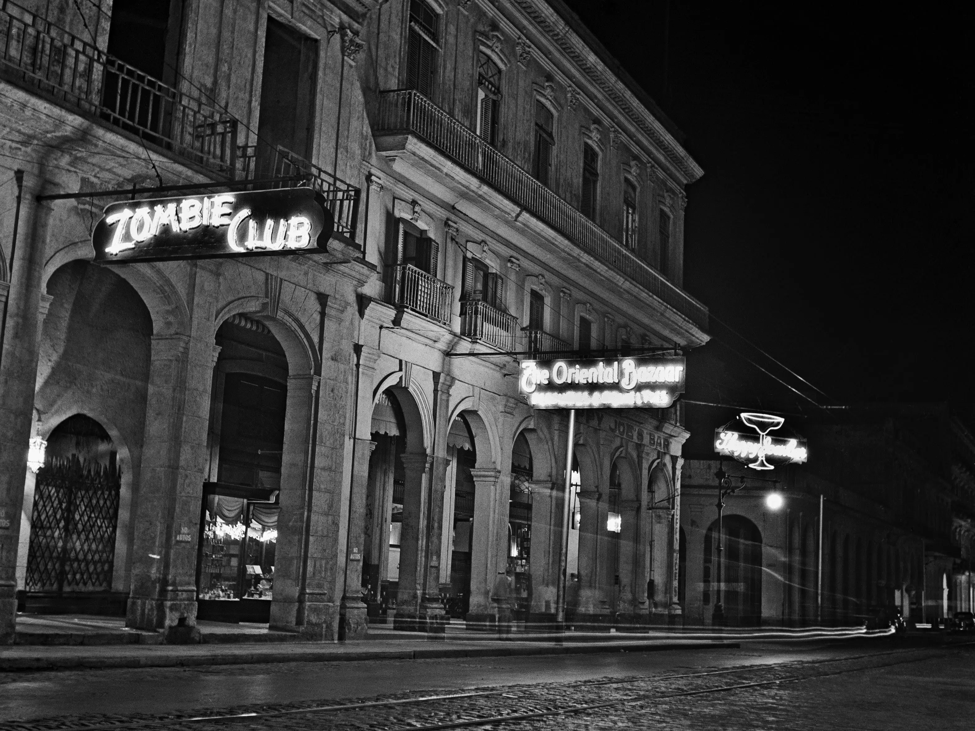 HAVANA CUBA - 1946: An exterior of Zulueta Street showing Sloppy Joe's Bar, The Oriental Bazaar and the Zombie Club in 1946 in Havana, Cuba. Both food historians and linguists believe that the Sloppy Joe sandwich originated at this bar.