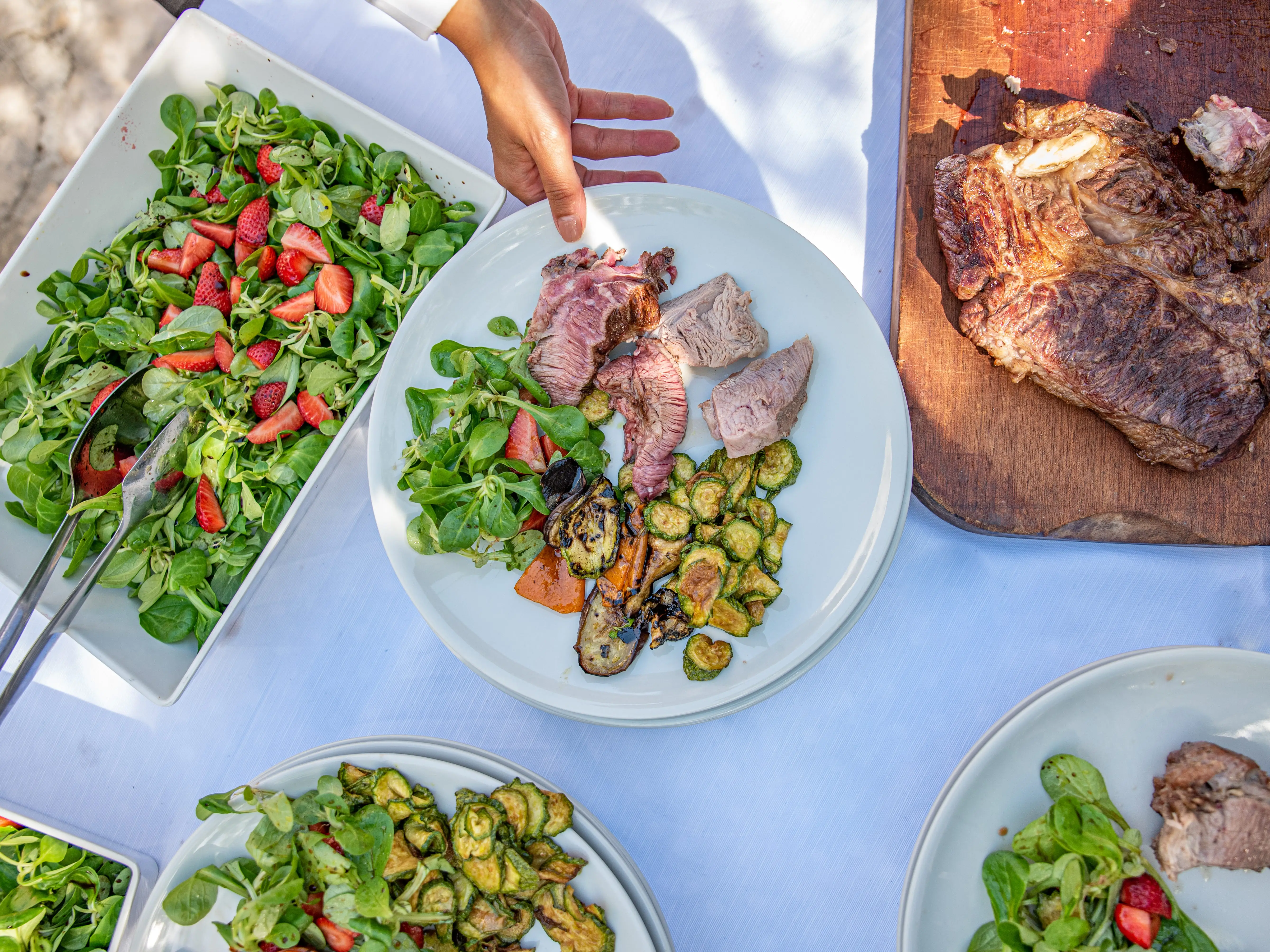 table with meat, salad, vegetables