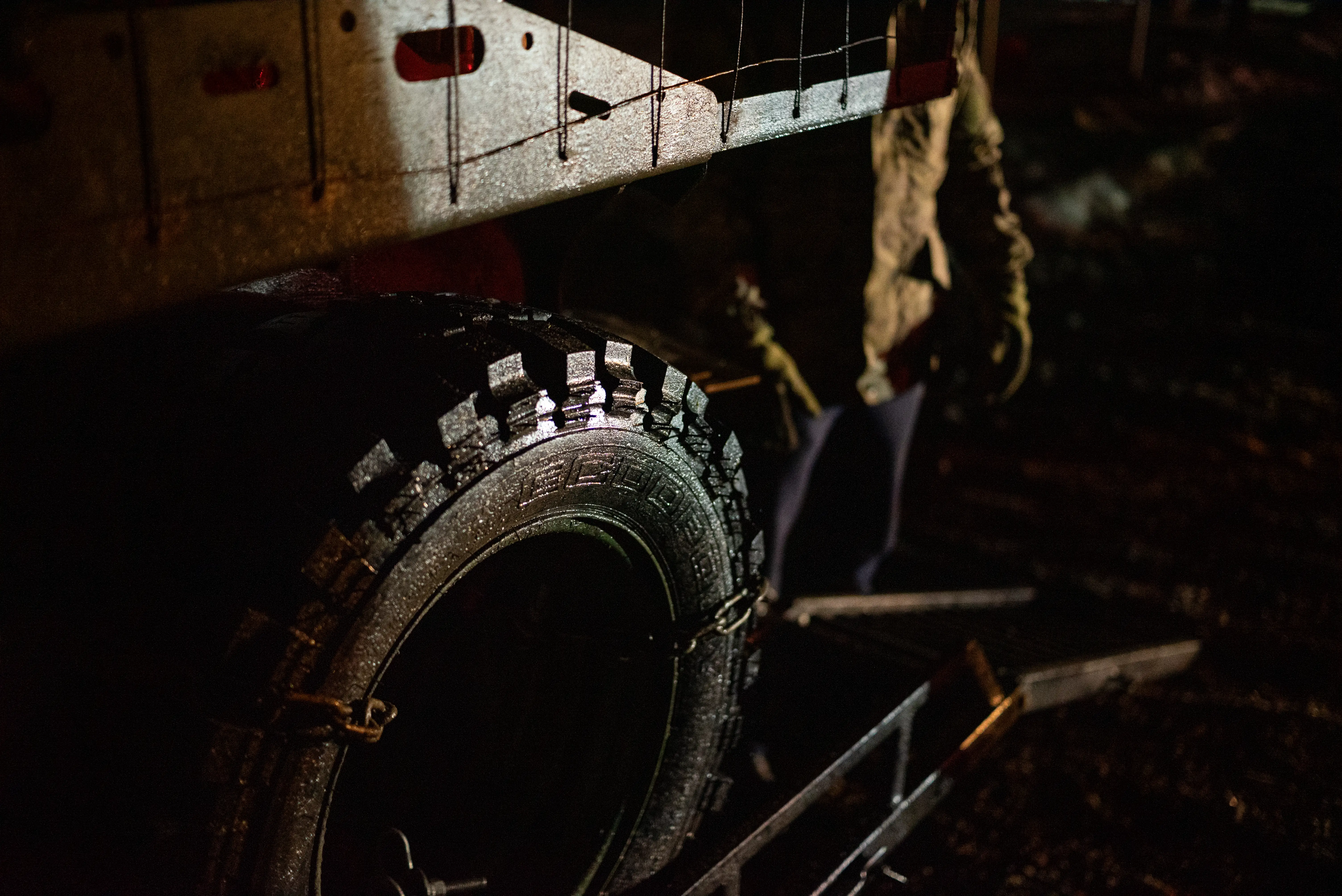 A Ukrainian serviceman watches as an uncrewed ground vehicles is loaded on a platform.