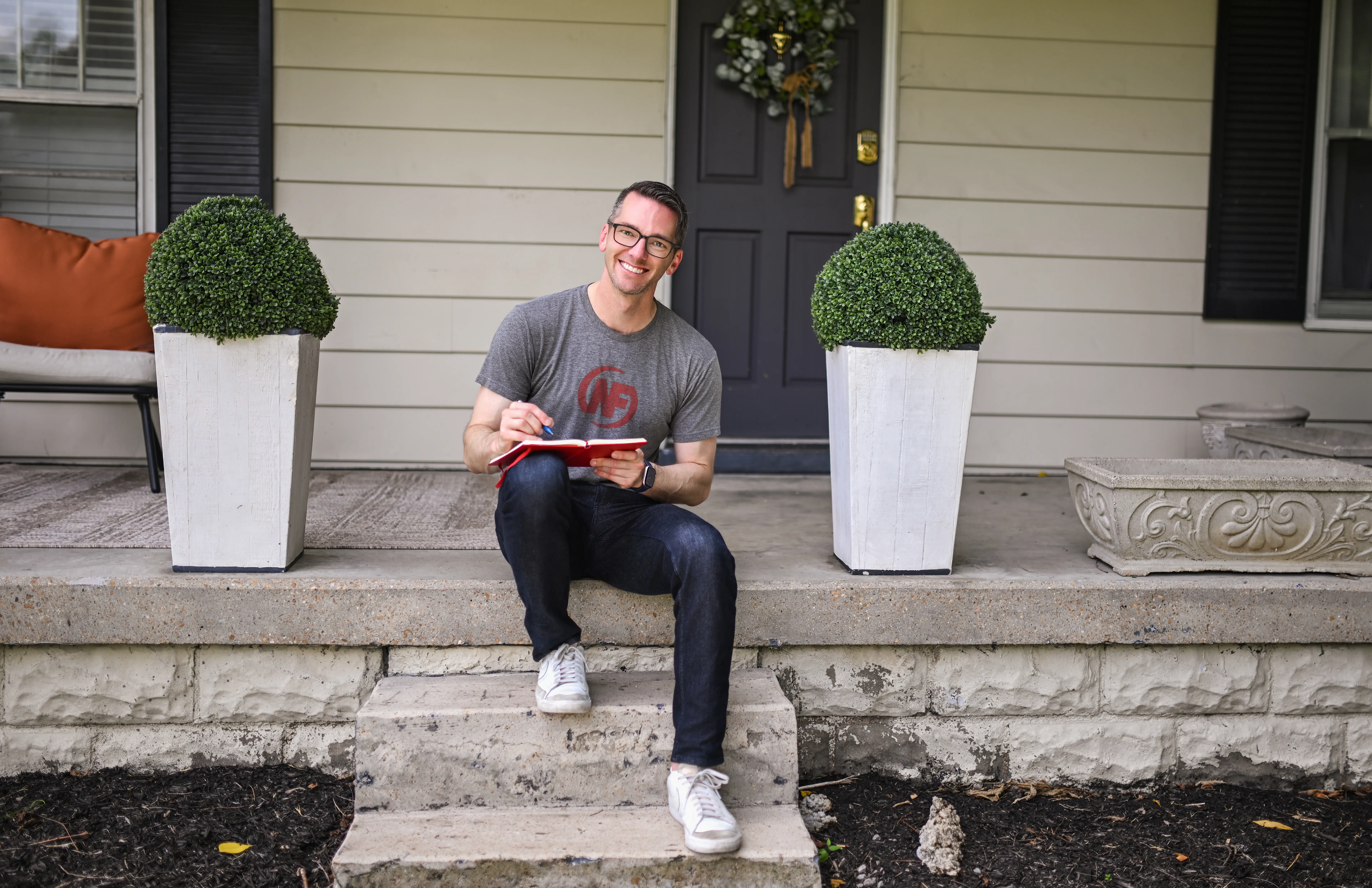A man sits on a porch.