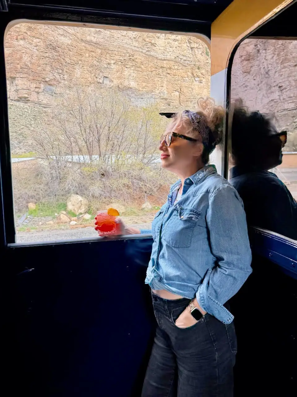 The author drinking a colorful drink on the train.