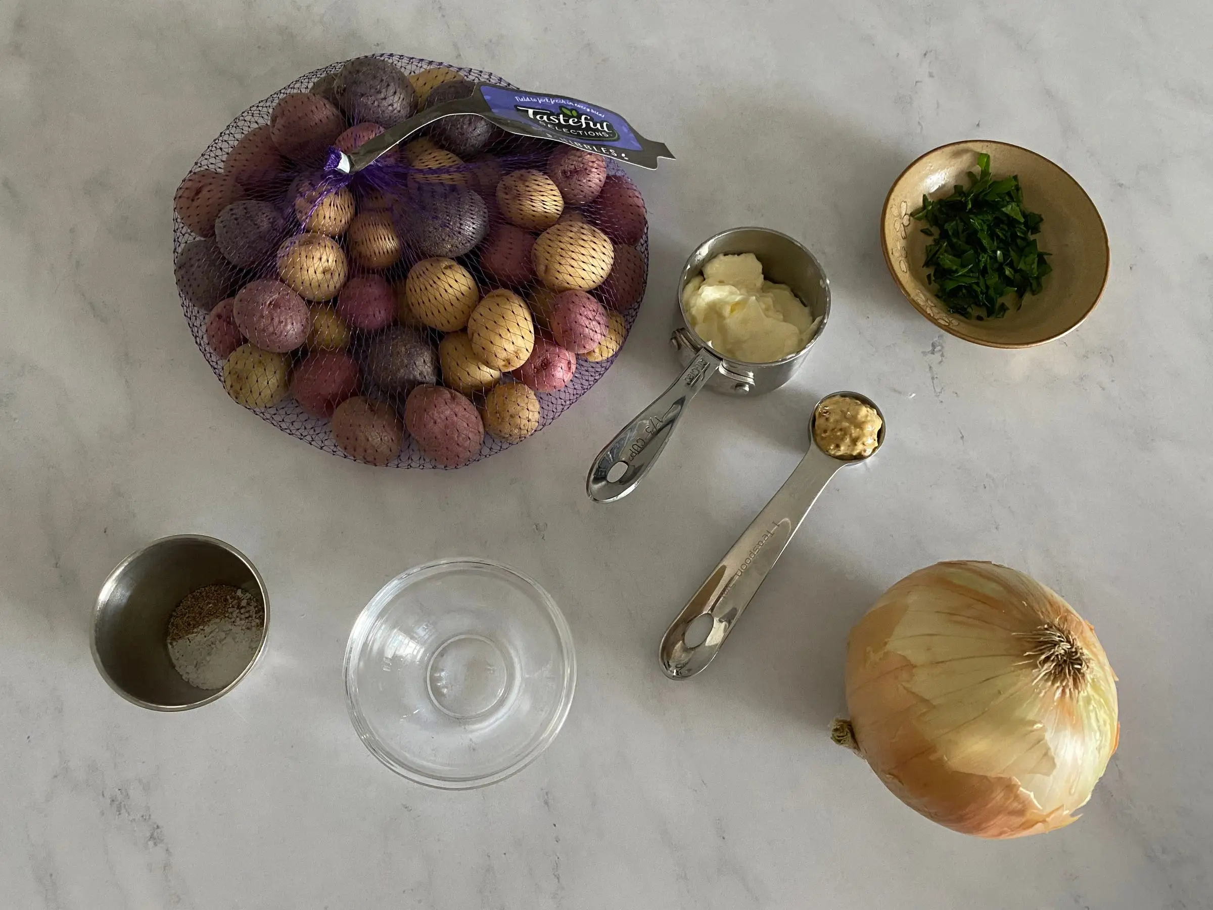 bag of potatoes, onion, mustard, and other ingredients