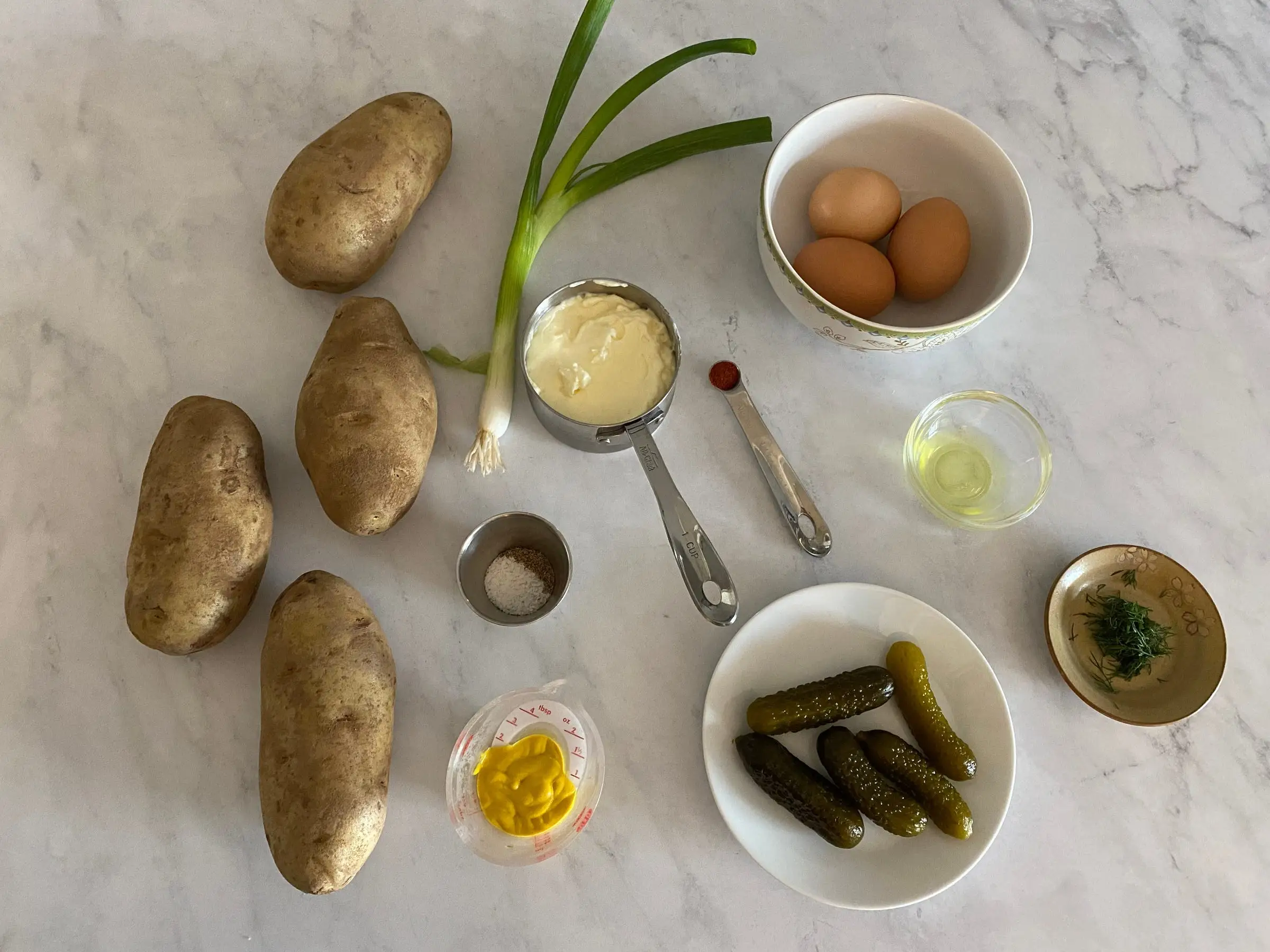potatoes, green onion, and other ingredients laid out on counter