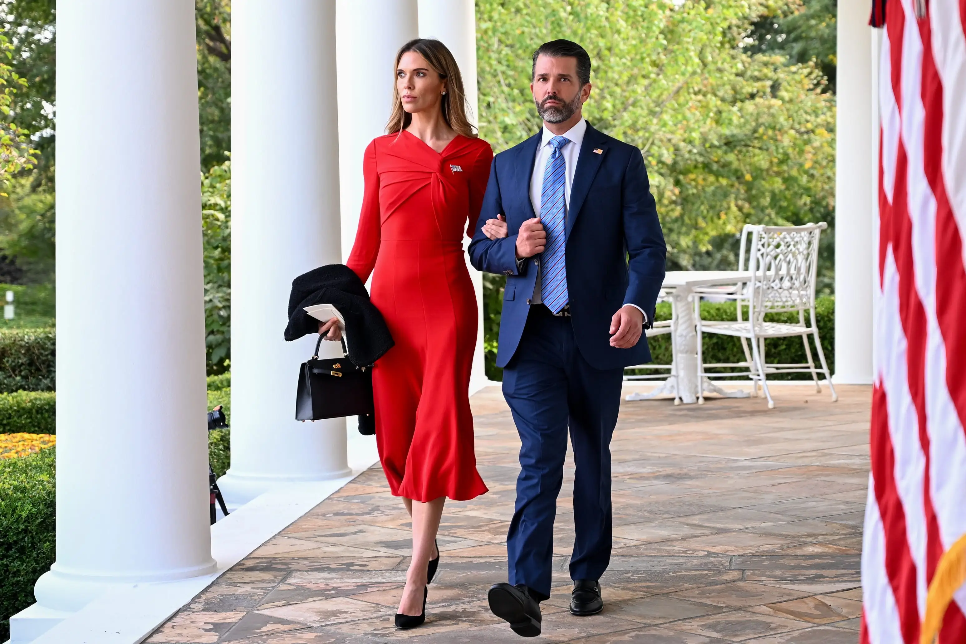 Bettina Anderson and Donald Trump Jr. walk arm in arm.
