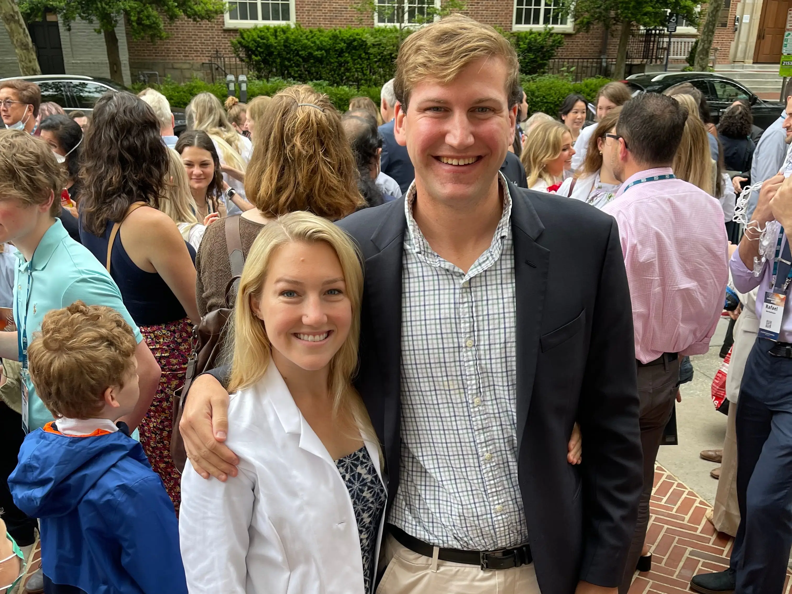 a woman poses in a white coat with her husband