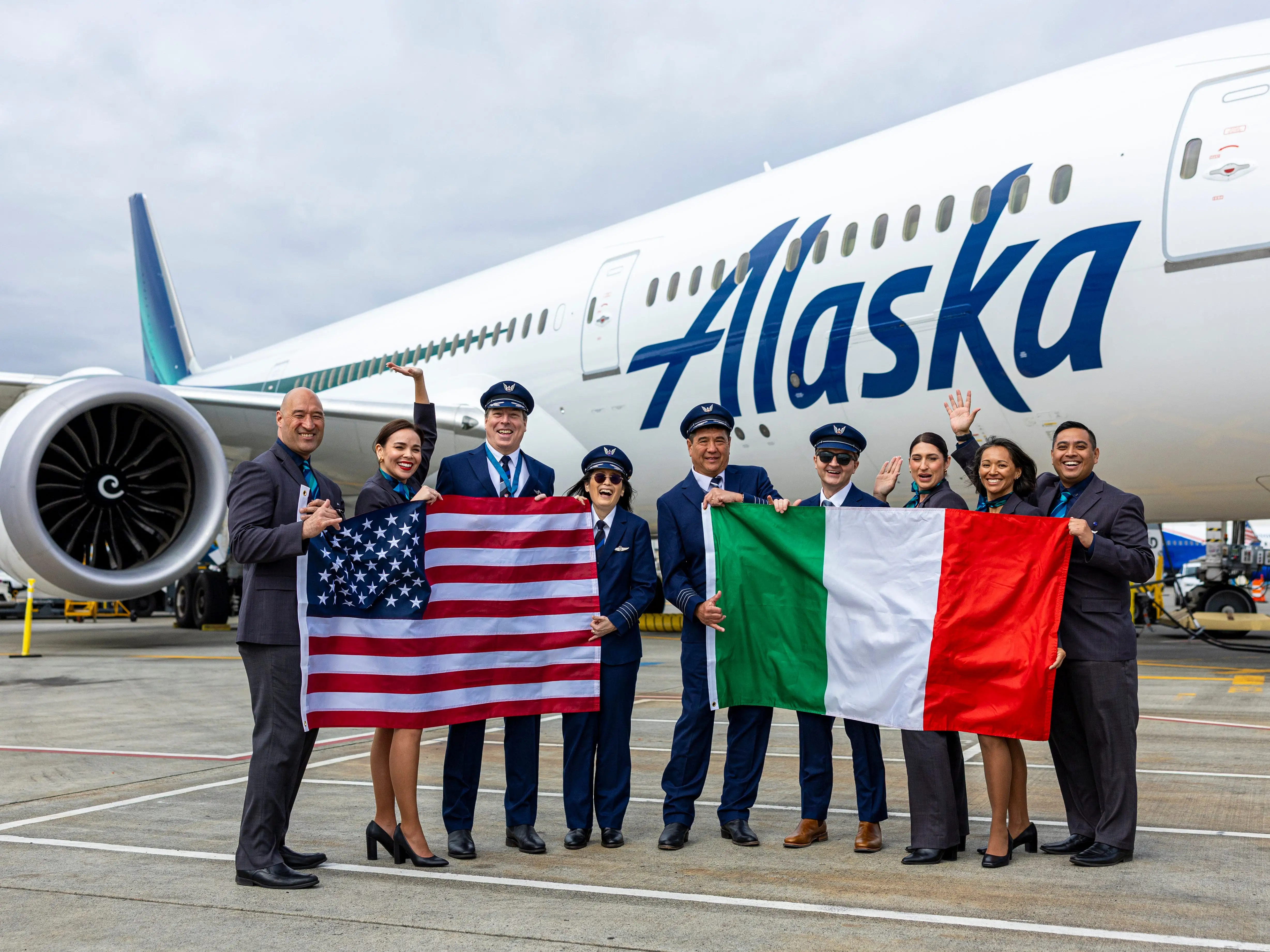 Alaska Airlines staff stand by one of the company's planes to celebrate its new route from Seattle to Rome.