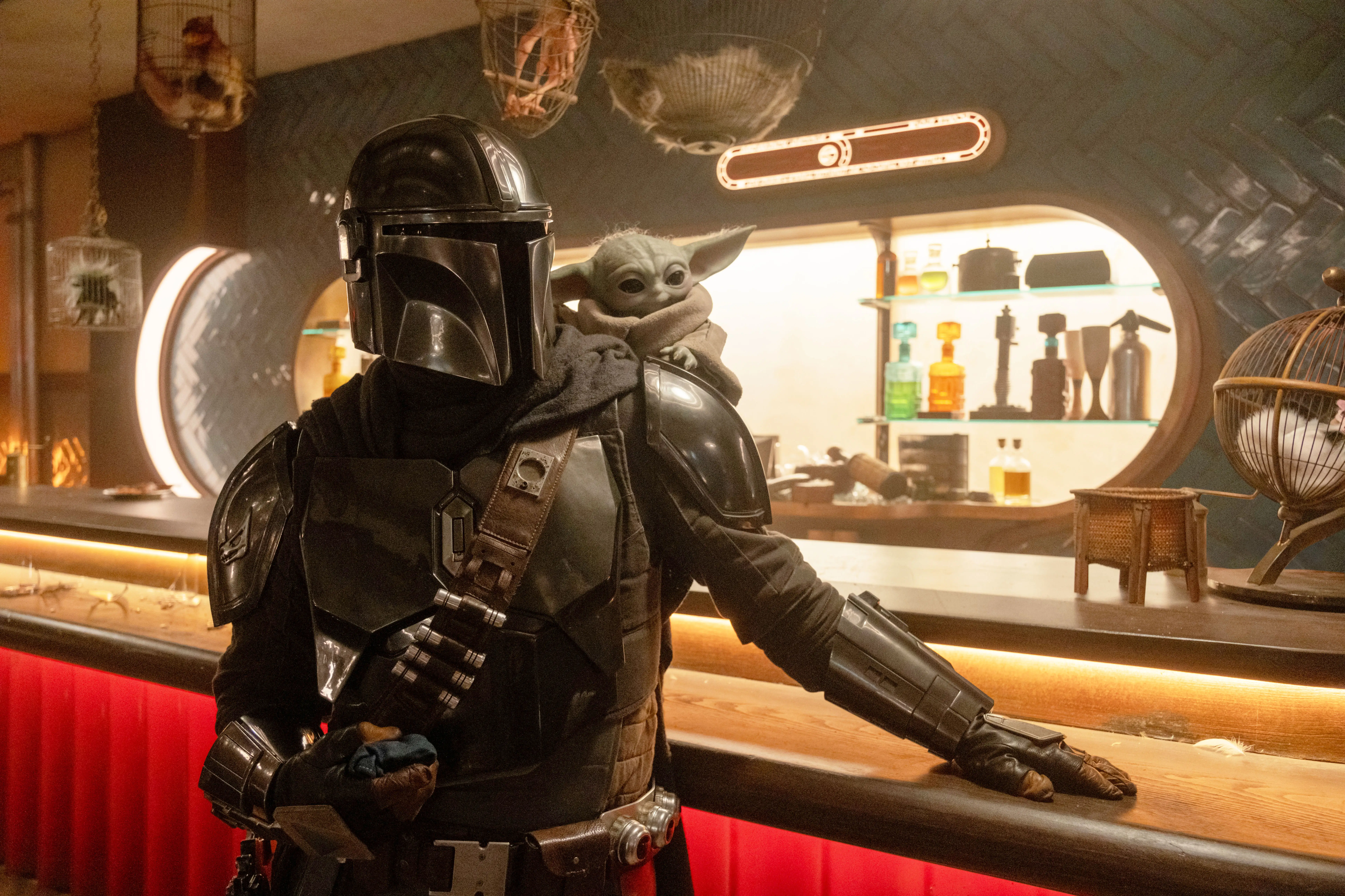 The Mandalorian and Grogu at a bar