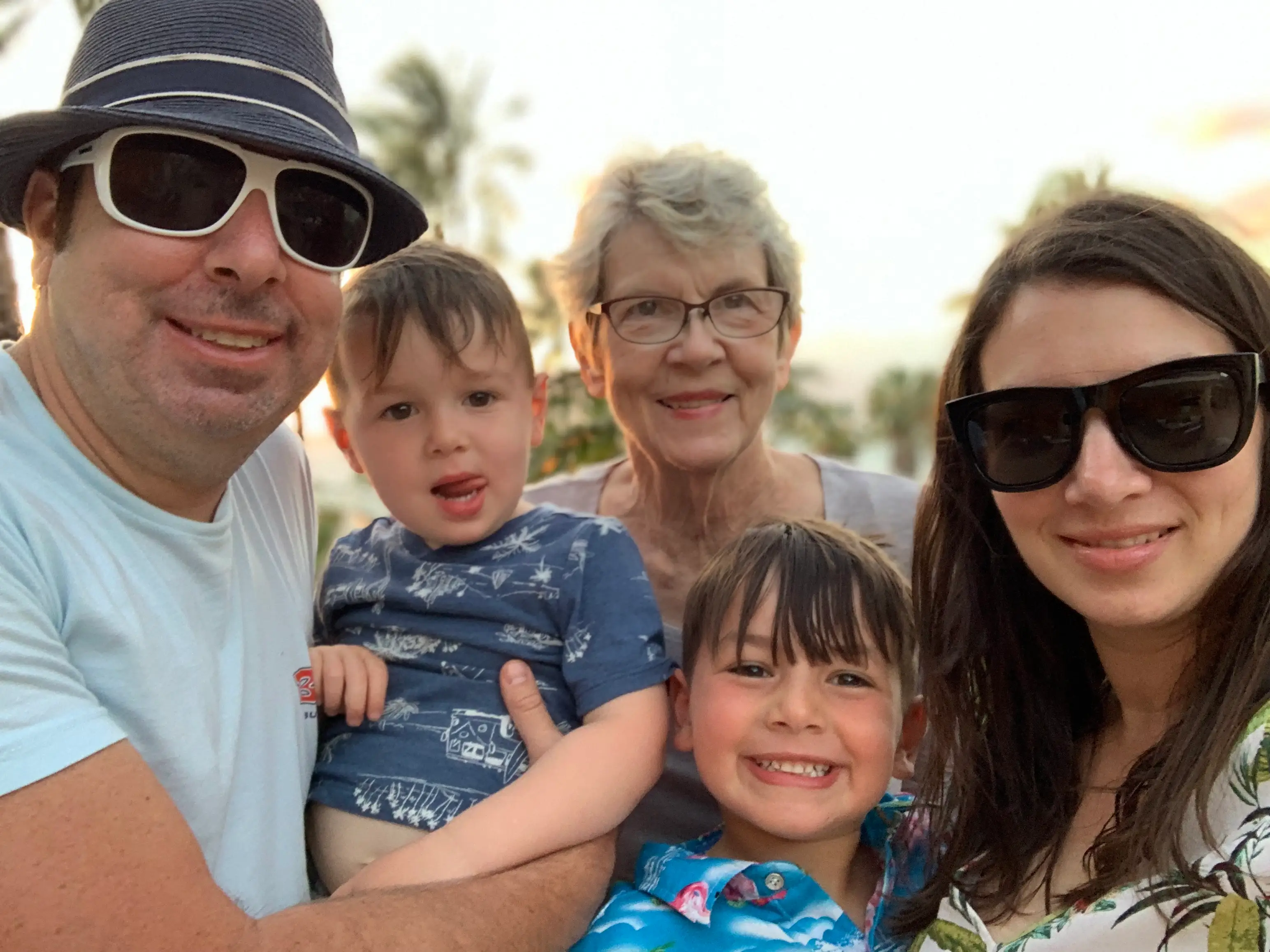 A family of five, including two young boys and their grandma.
