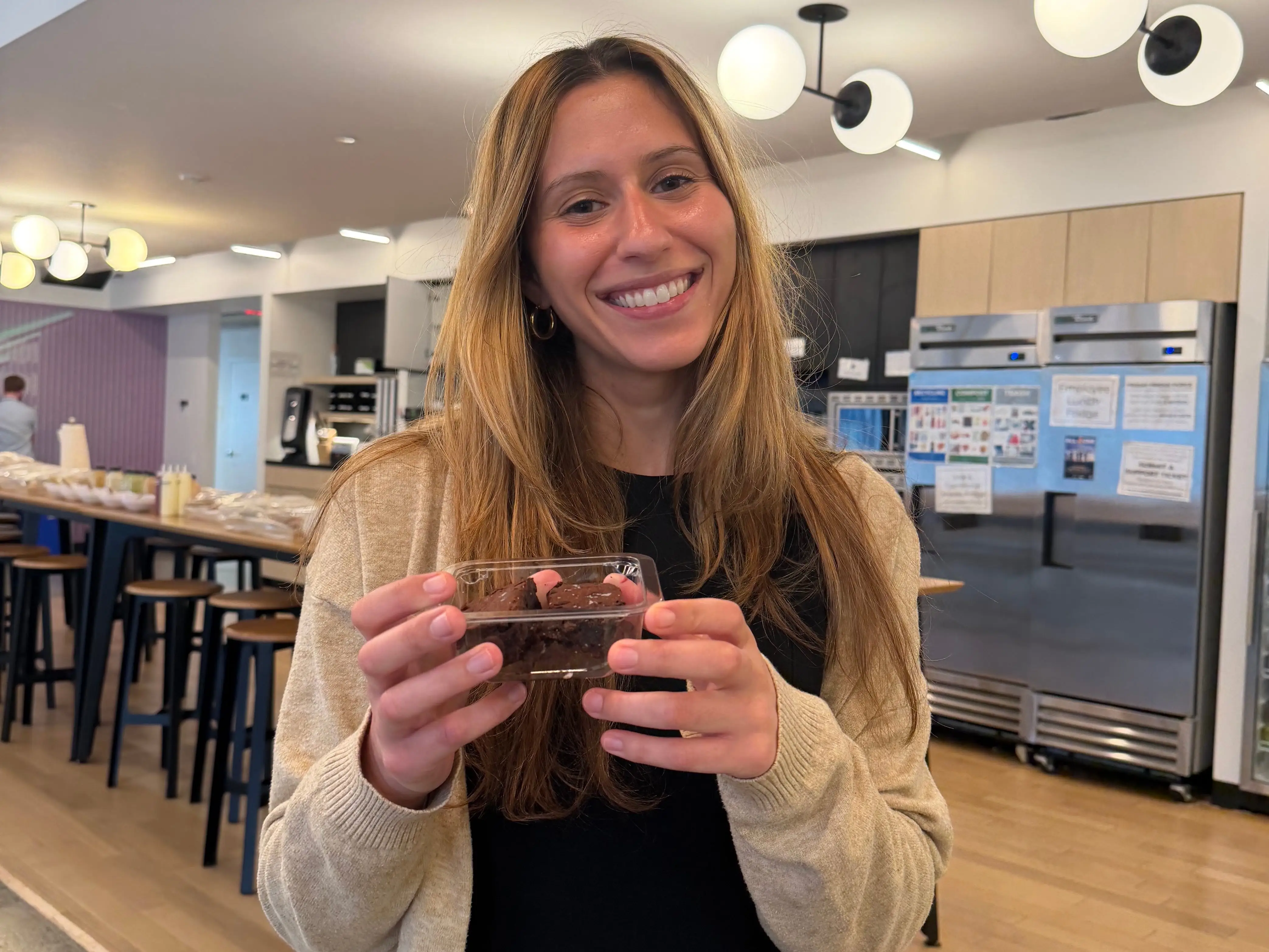 Business Insider's Ana Altchek is pictured holding a brownie from Goop Kitchen.