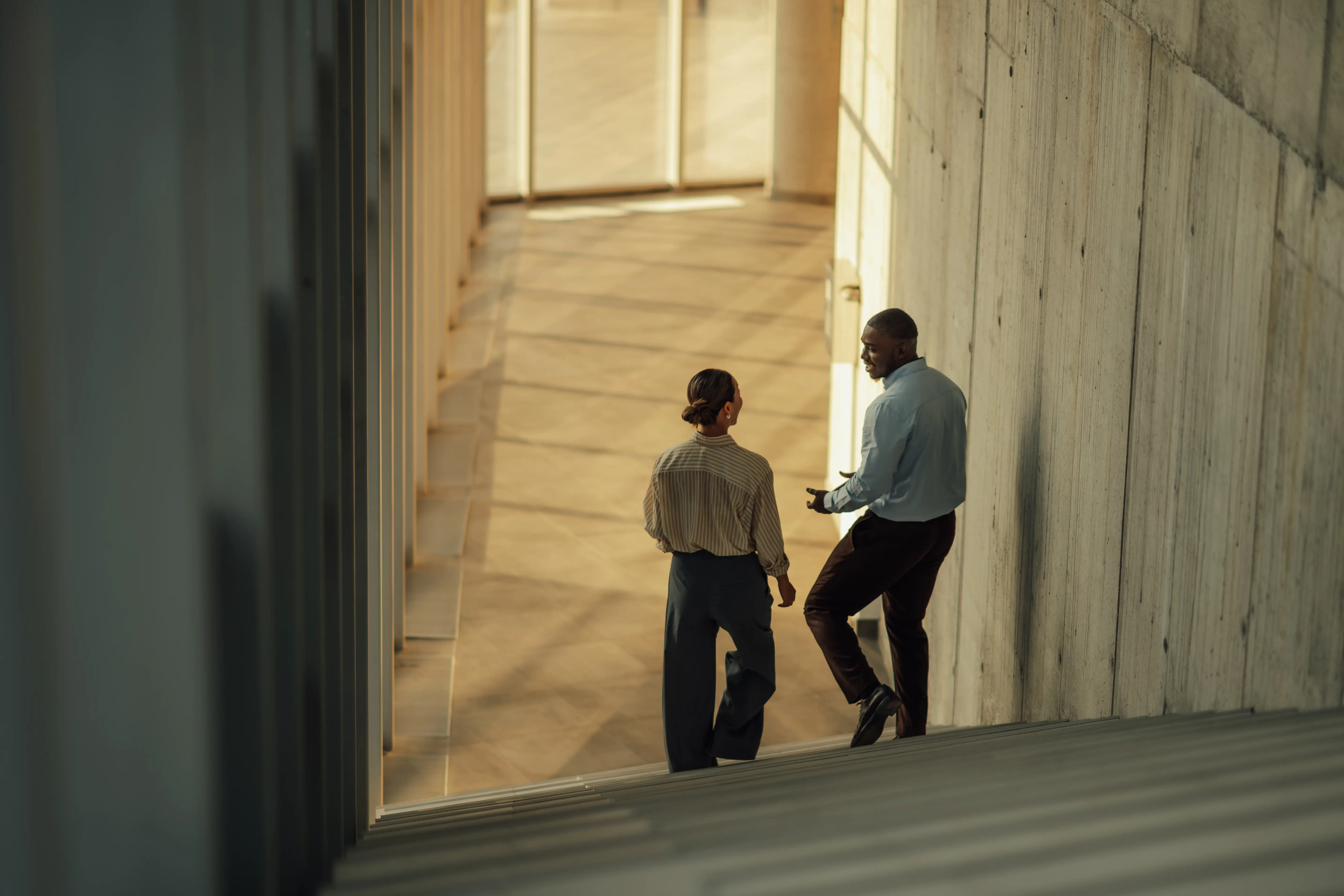 Two people talking on the stairs