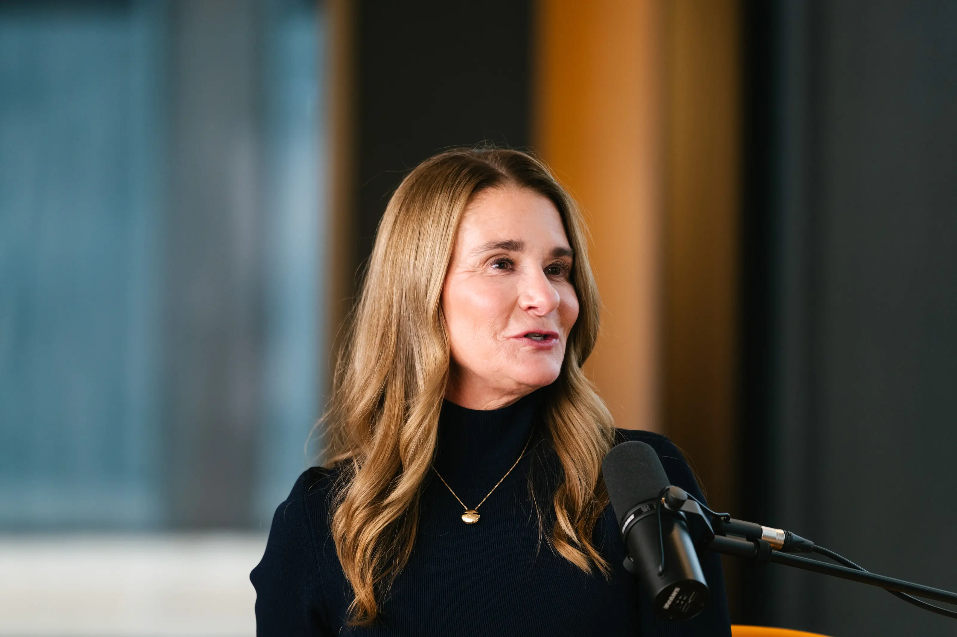 Melinda French Gates talks into a black microphone.