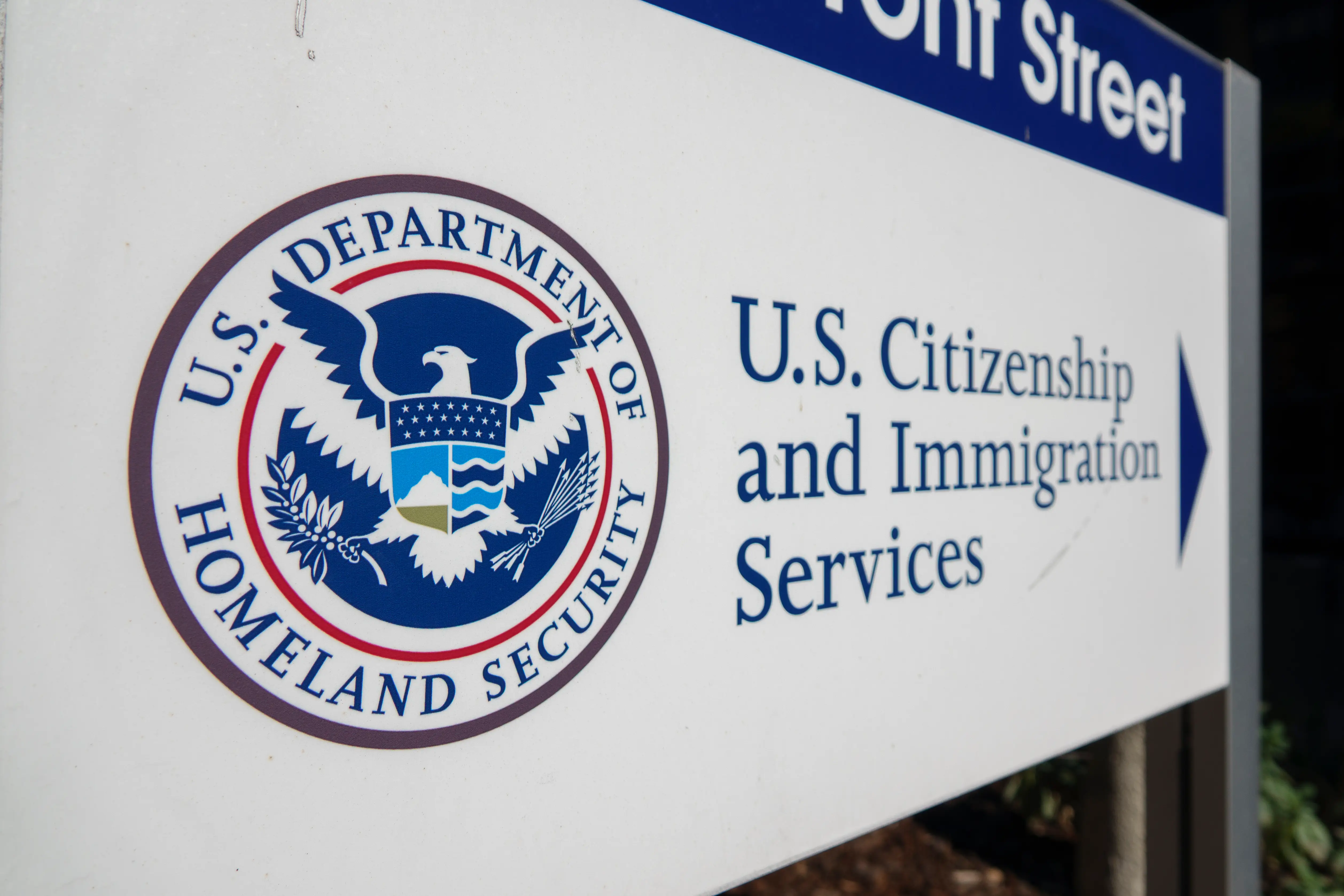 A Department of Homeland Security logo next to a sign for US Citizenship and Immigration Services