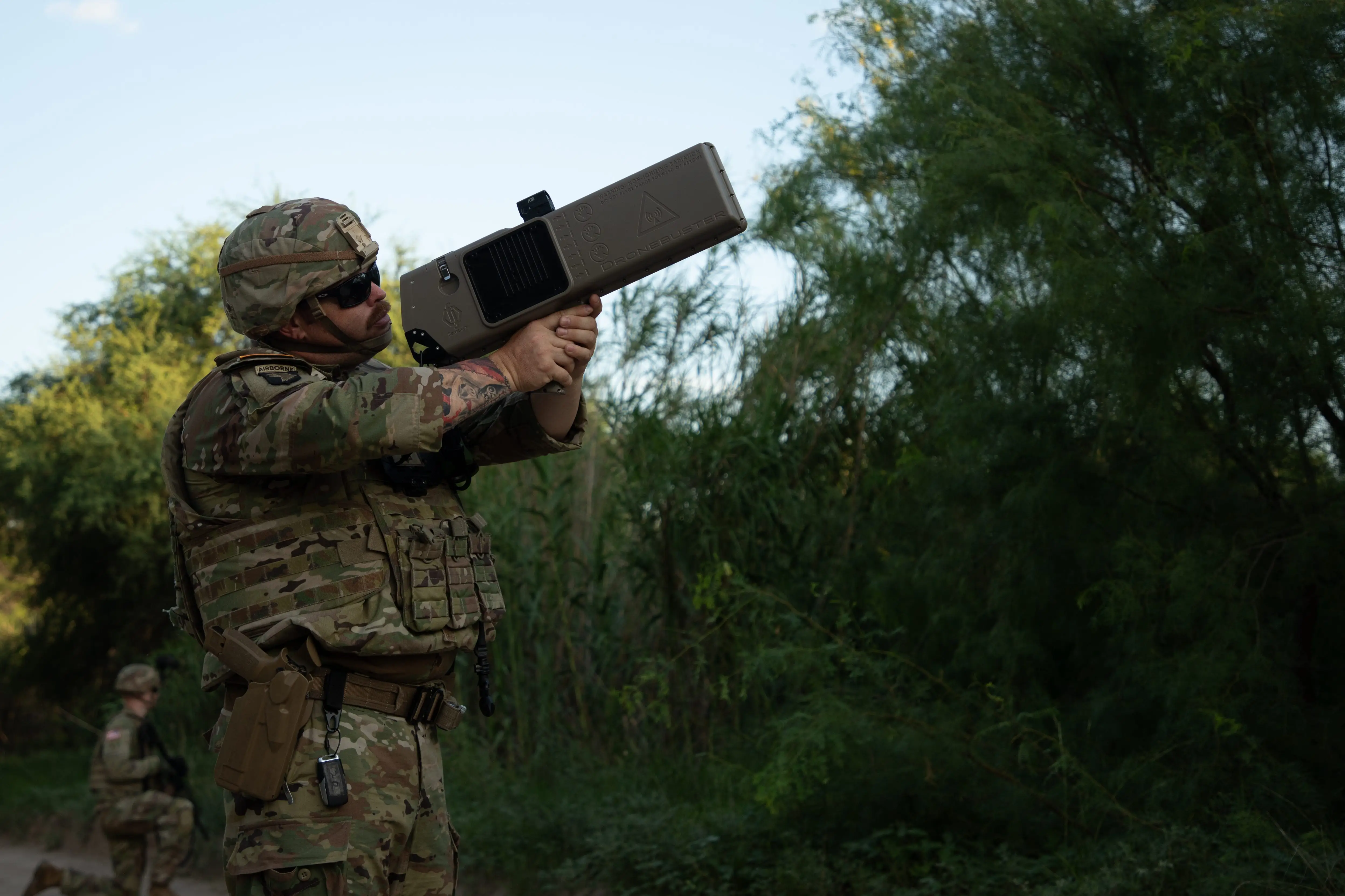 A soldier uses a Dronebuster counter-drone tool during a patrol along the Rio Grande River near Eagle Pass, Texas, June 14, 2025.