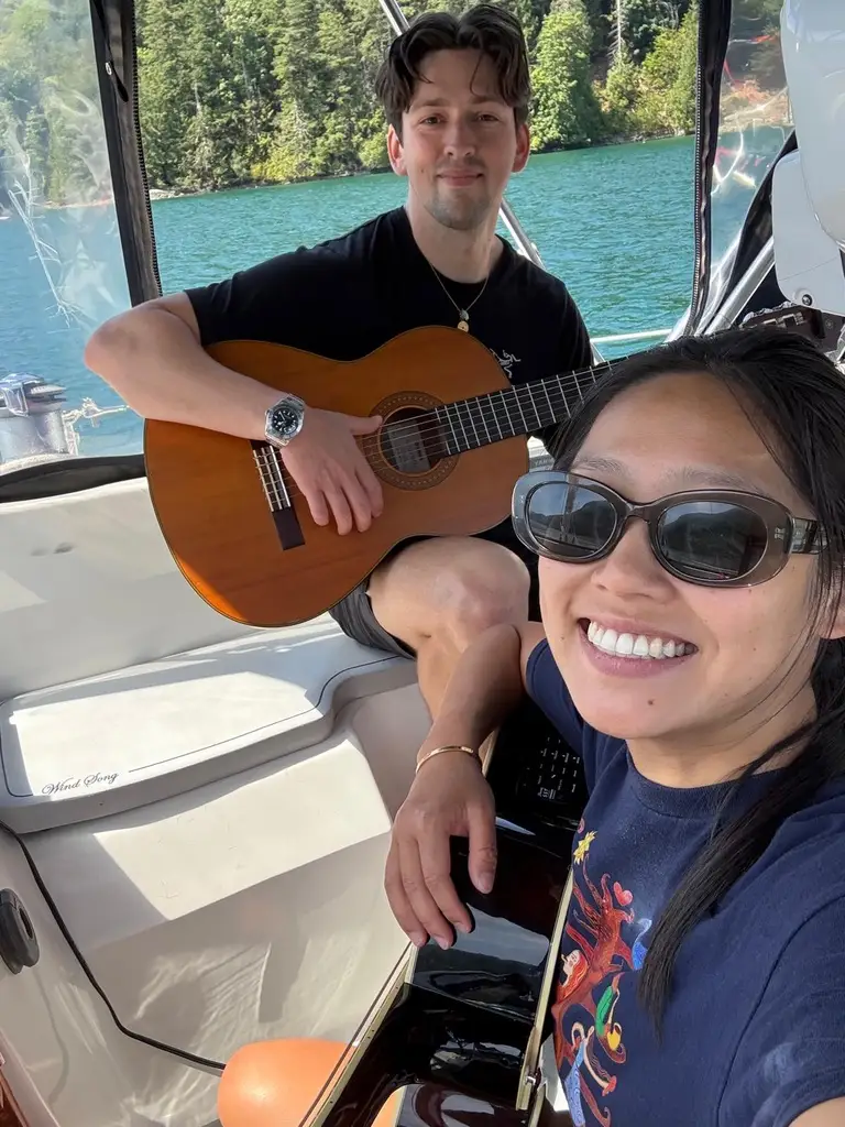 Couple on boat playing guitar