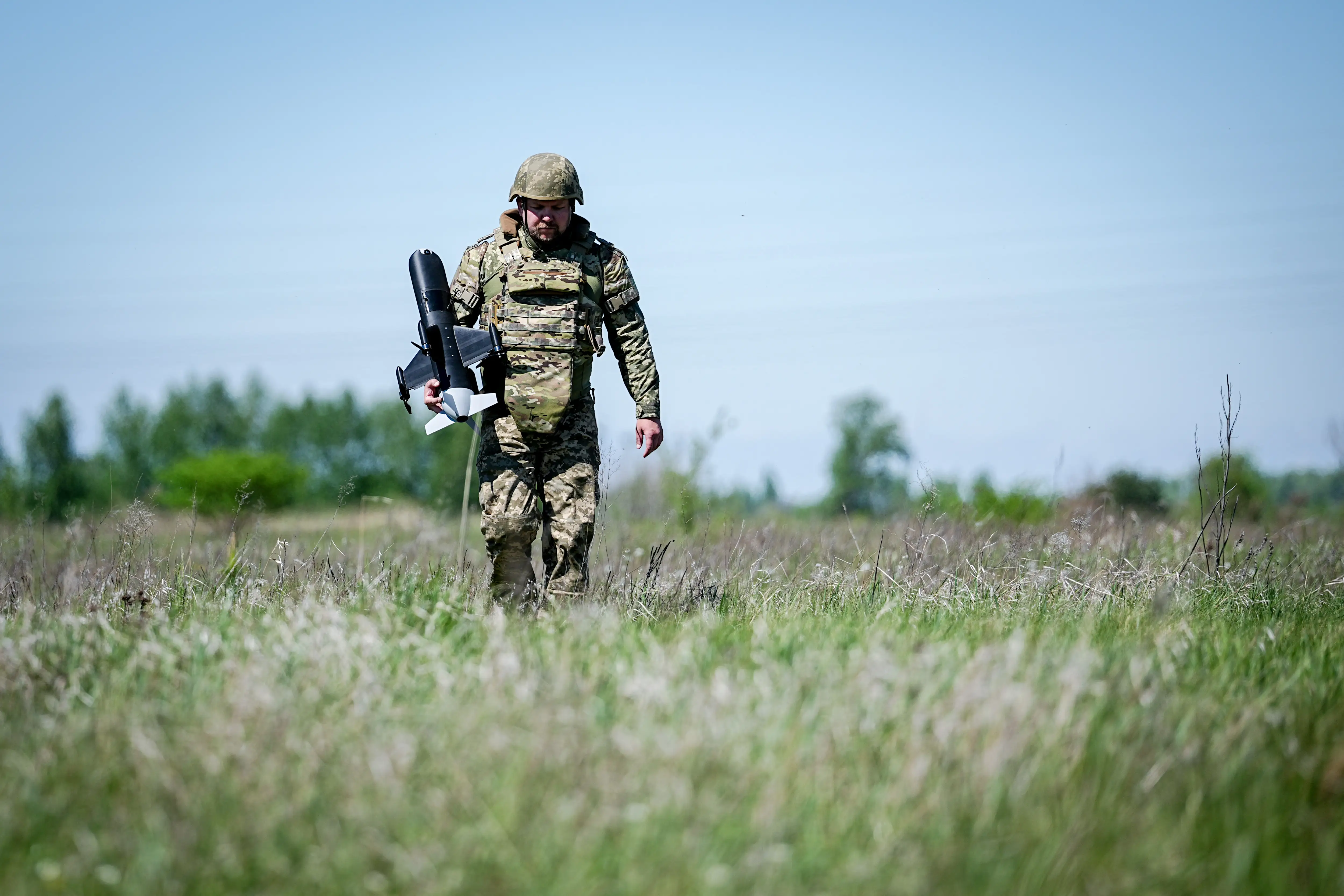 A Ukrainian soldier returns an interceptor drone after a test flight near Kyiv.