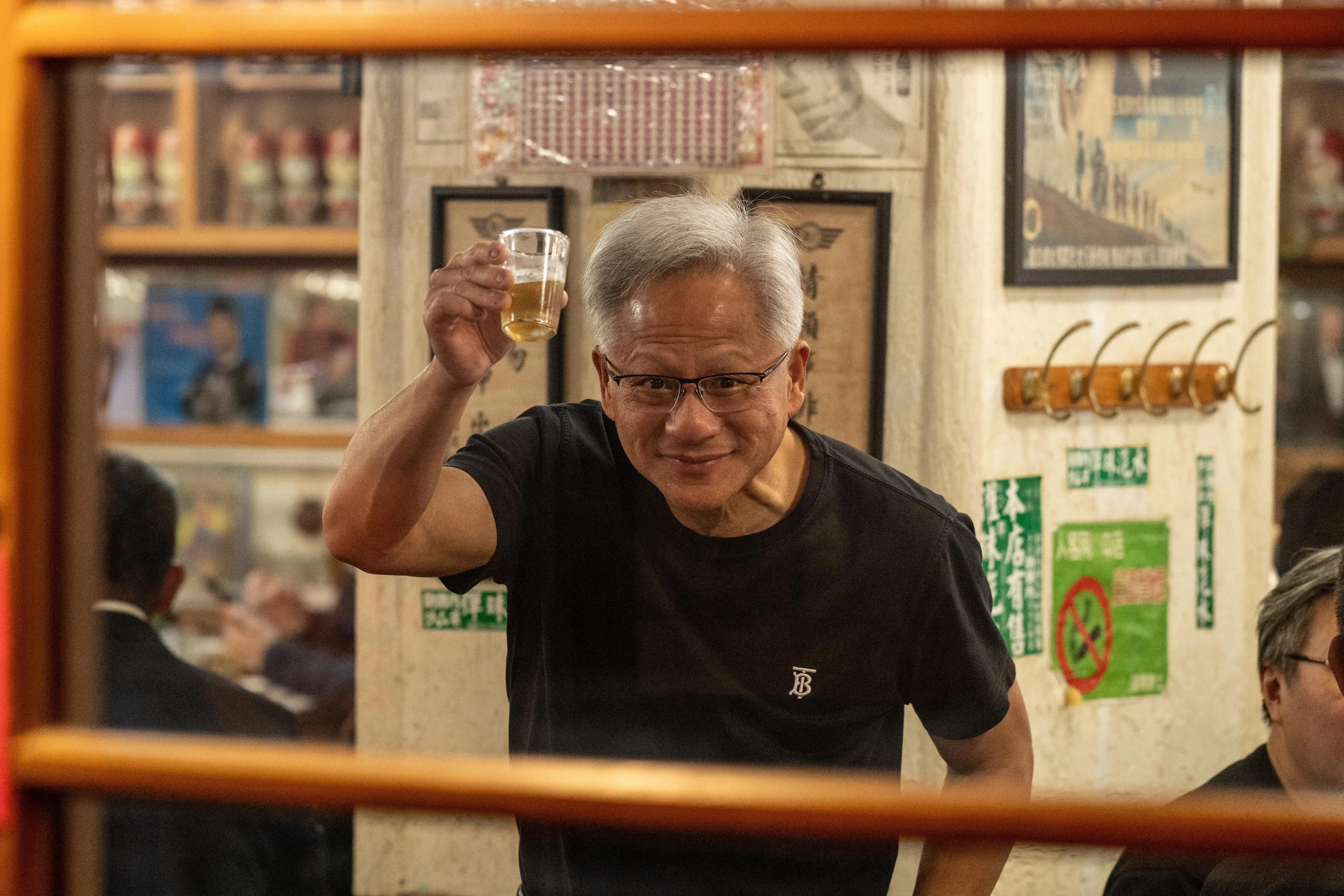 Jensen Huang, chief executive officer of Nvidia Corp., raises a toast during a dinner event with the company's Taiwanese suppliers in Taipei, Taiwan, on Saturday, Jan. 31, 2026