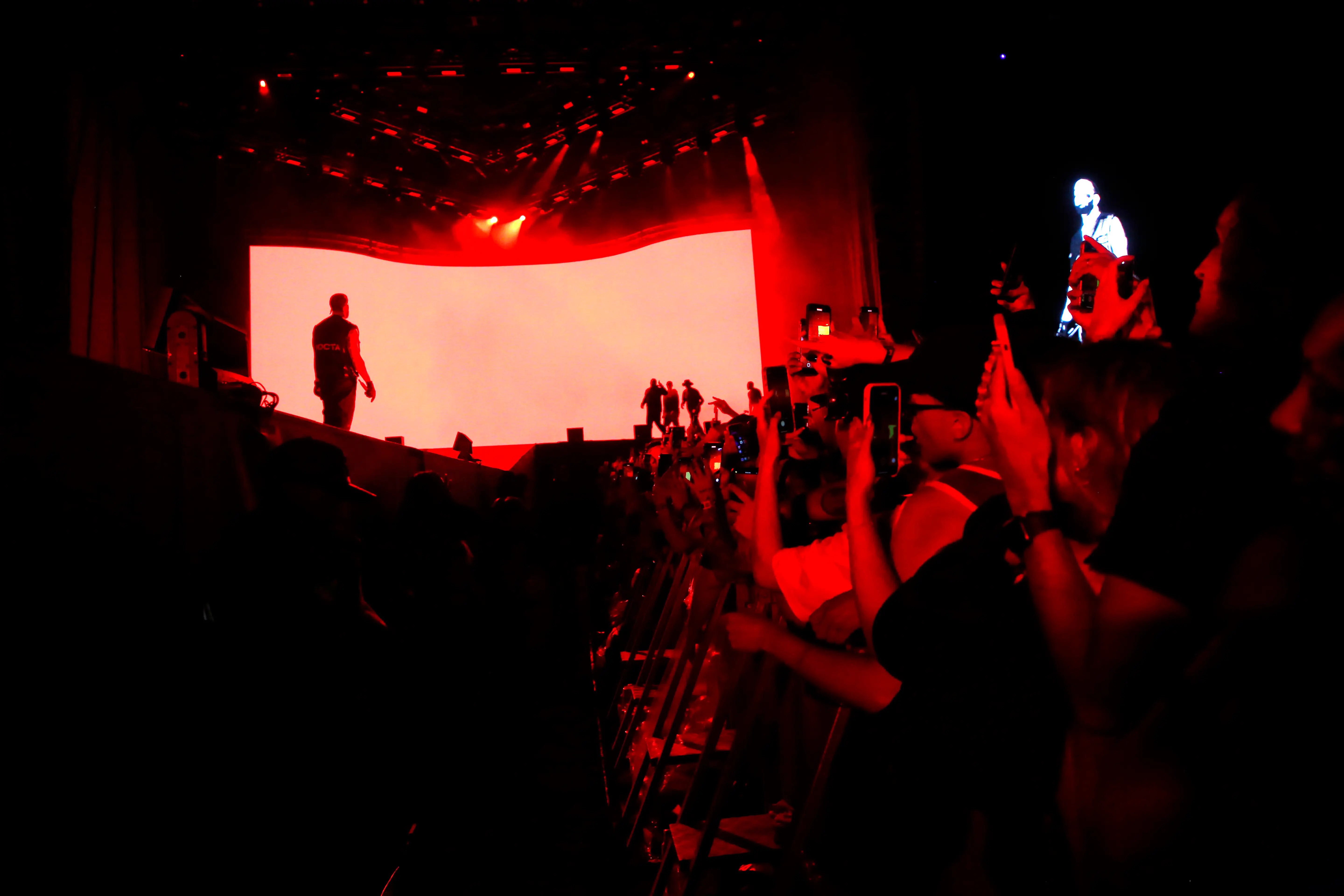 Fans filming Drake at Lollapalooza Chile in 2023.
