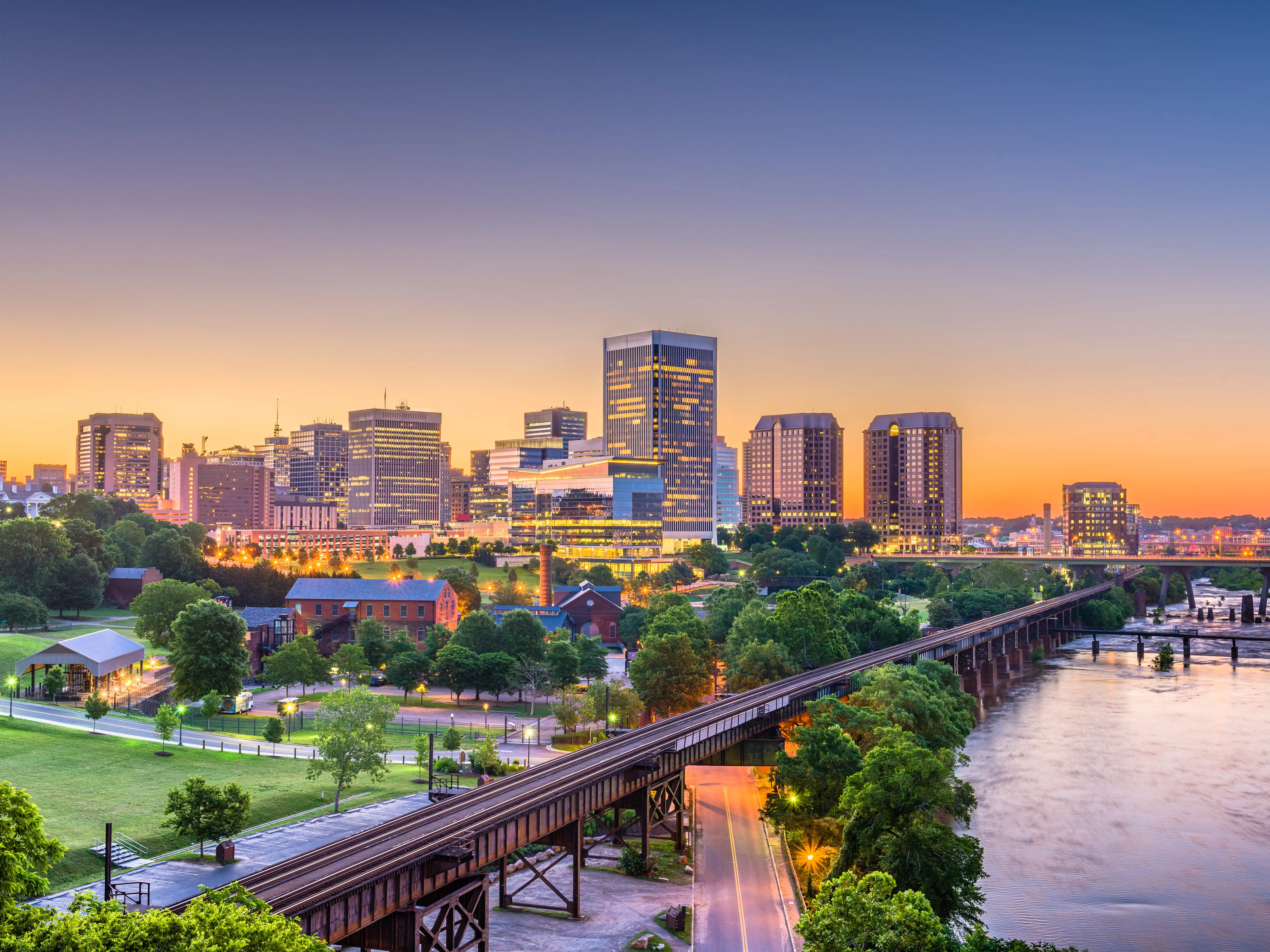 Richmond, Virginia, USA downtown skyline on the river at twilight.