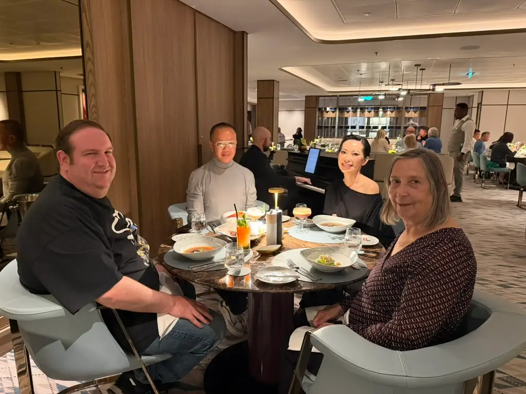 Group of people sitting at a table with food