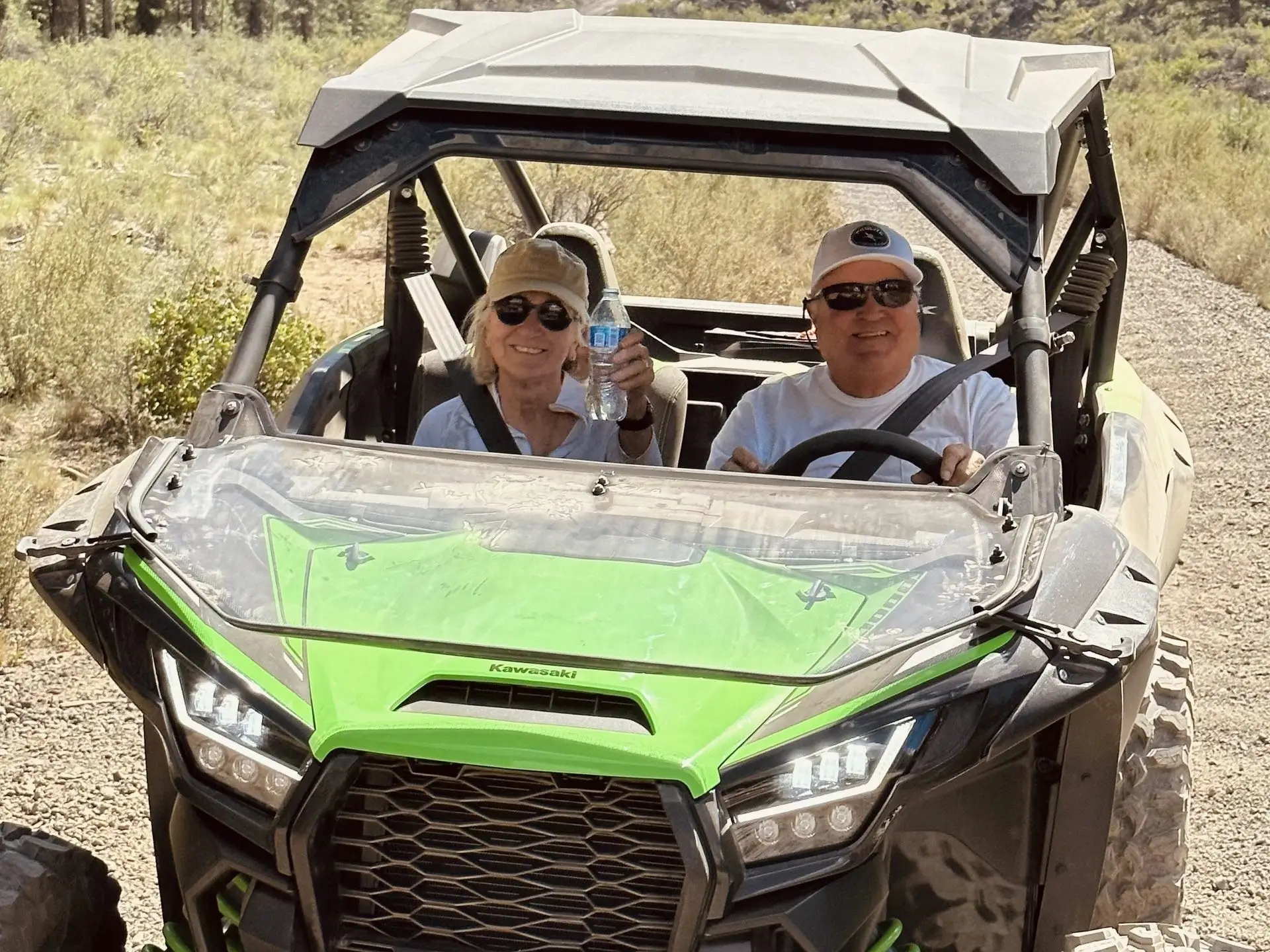 John Adams riding an ATV with his wife.