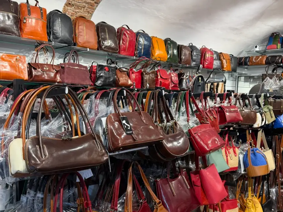 Rows of leather handbags at a shop in Florence, Italy.
