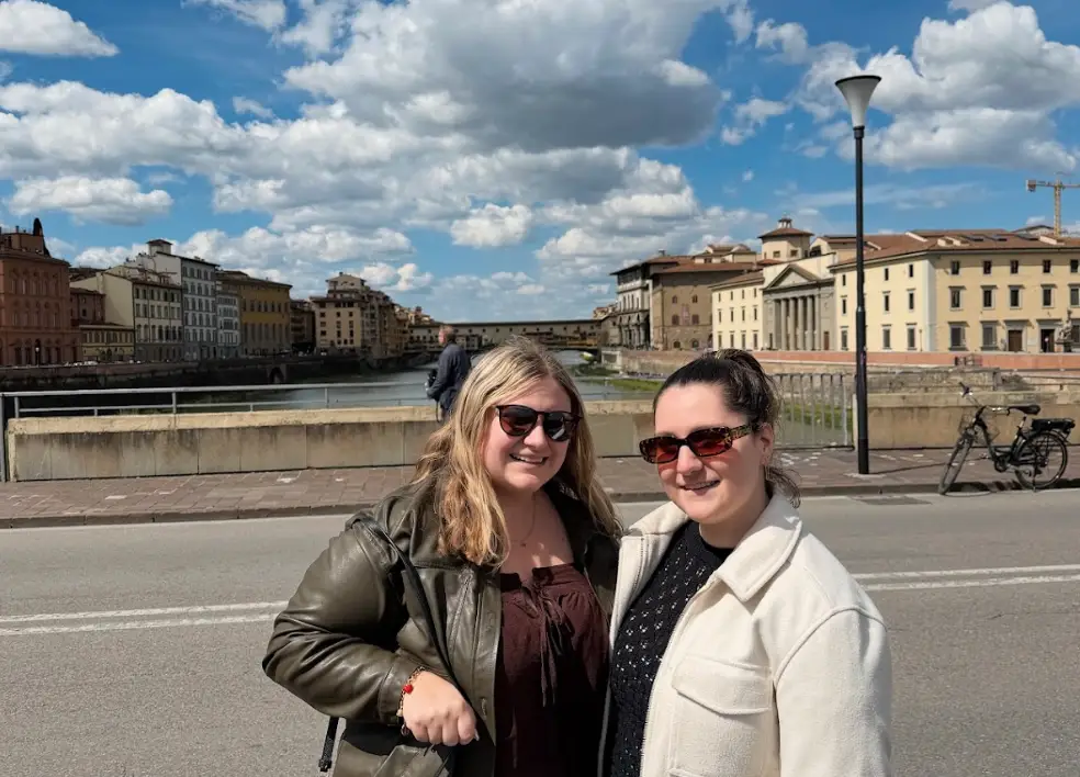 The writer and her sister posing in the street in front of the Ponte Vecchio in Florence, Italy.