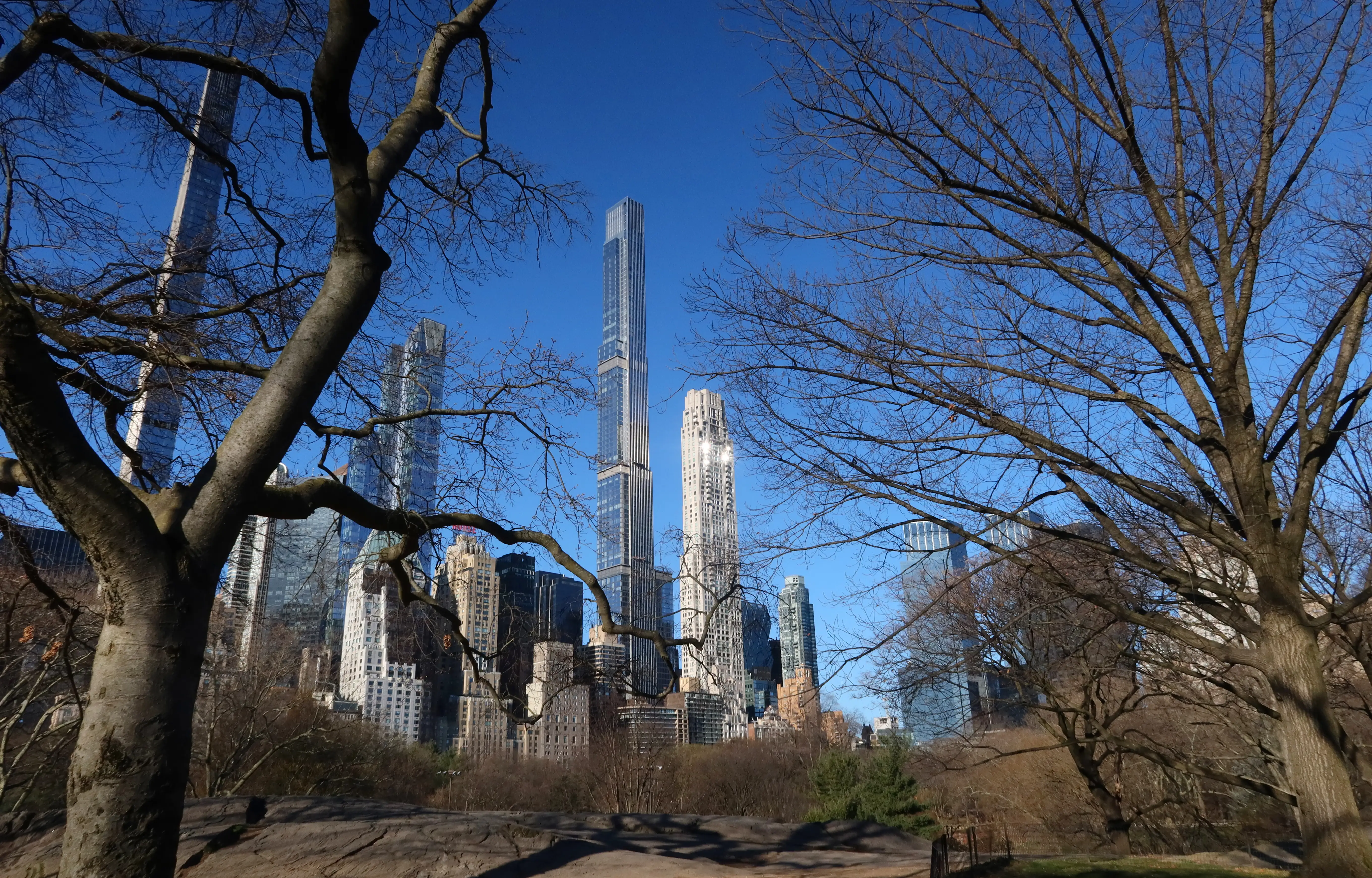 The sun rises on Central Park Tower and 220 Central Park South.