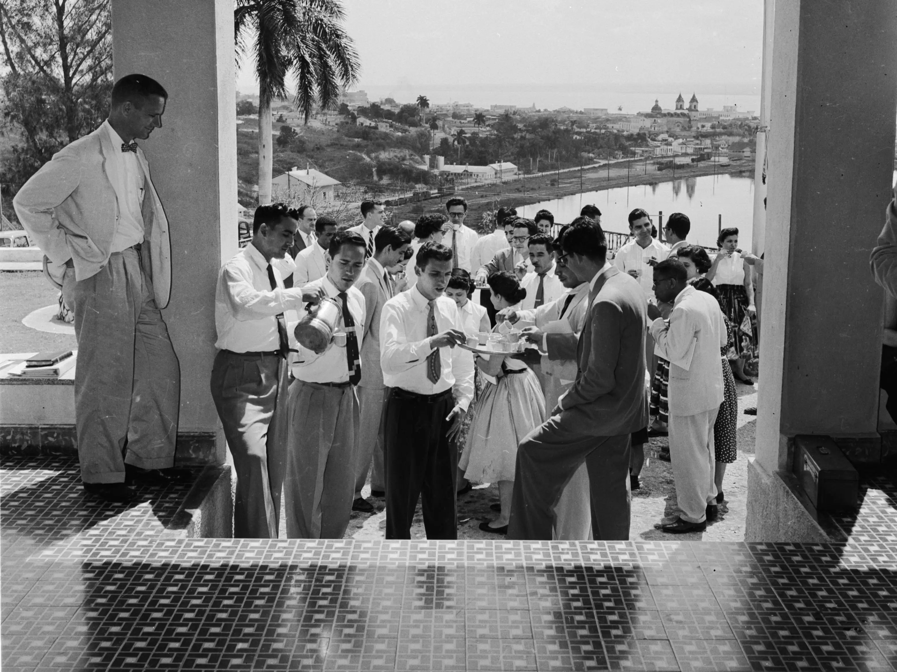 circa 1956: Students taking a coffee break at the Theological Seminary in Matanzas, Cuba. Matanzas can be seen in the background.
