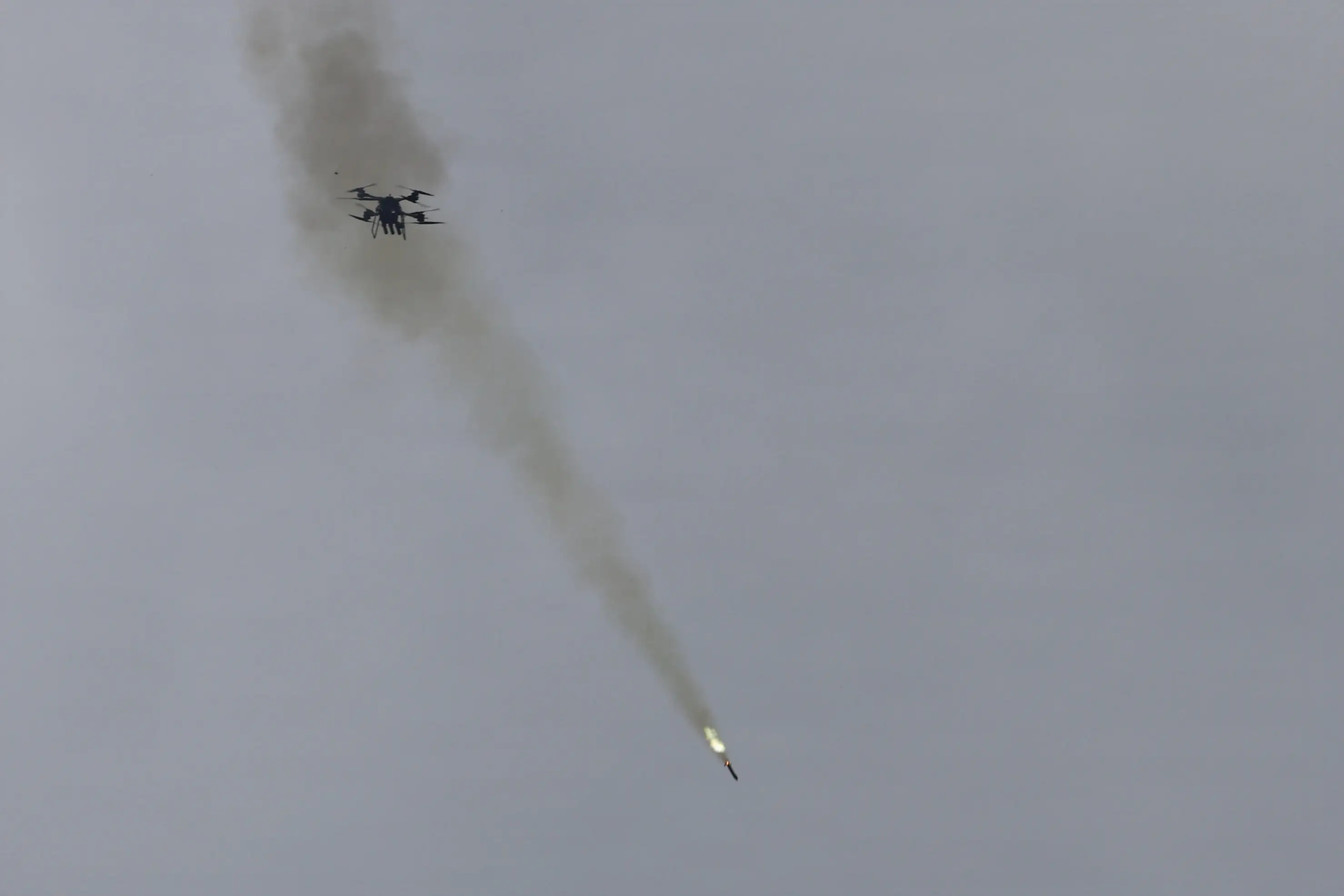A drone fires a rocket in the sky.
