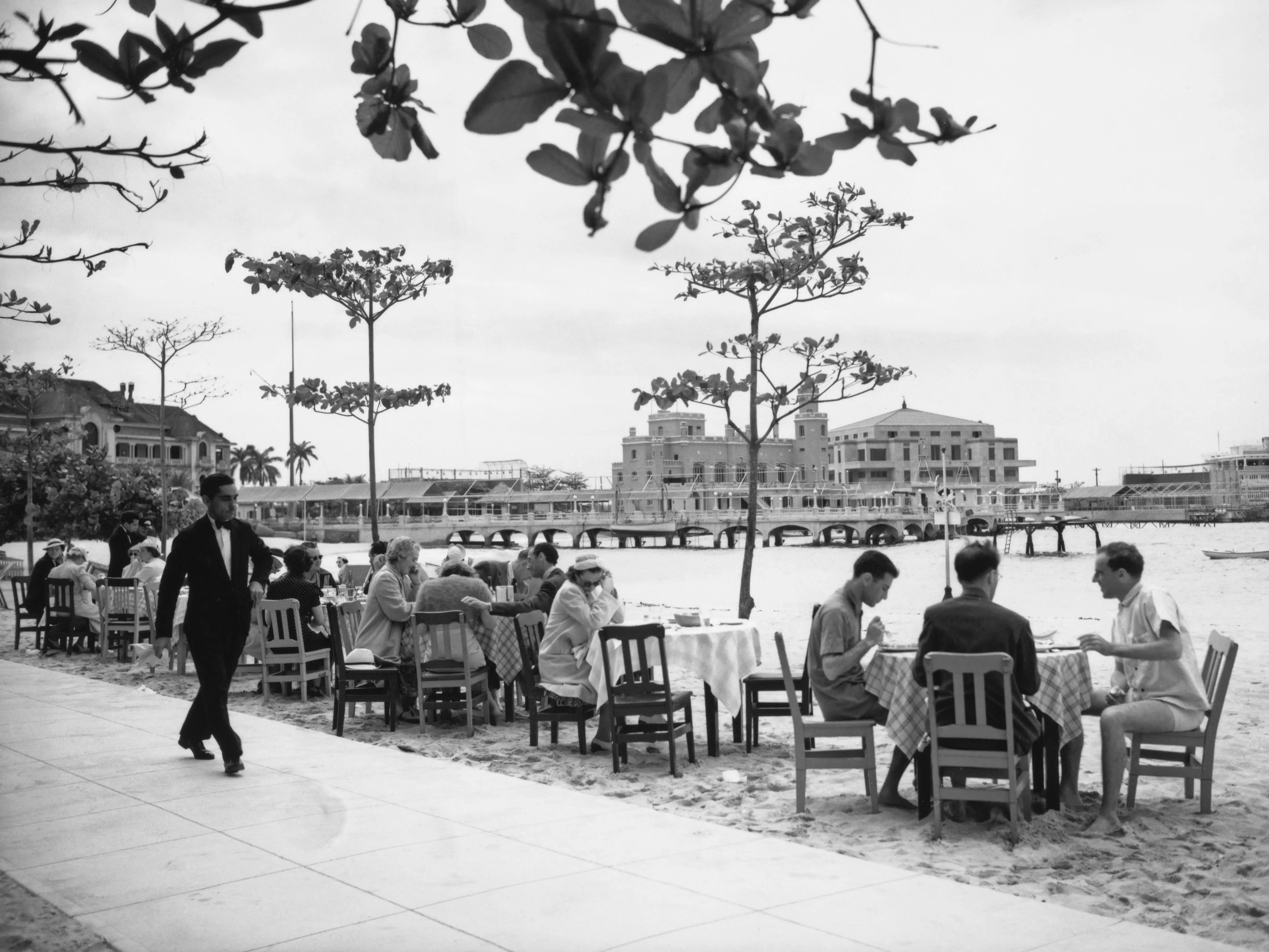 Holidaymakers at an outdoor café on La Concha beach at Marianao in Havana, Cuba, March 1939.
