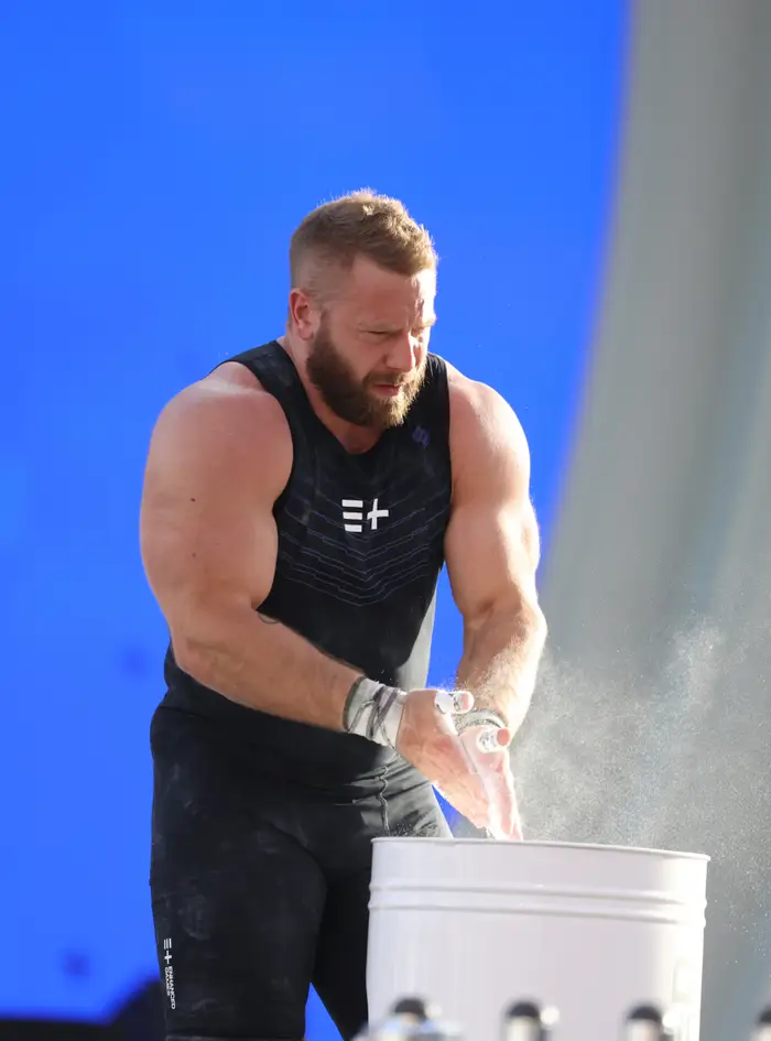 Wes Kitts chalks his hands before competing in the mens snatch during in the 2026 Enhanced Games