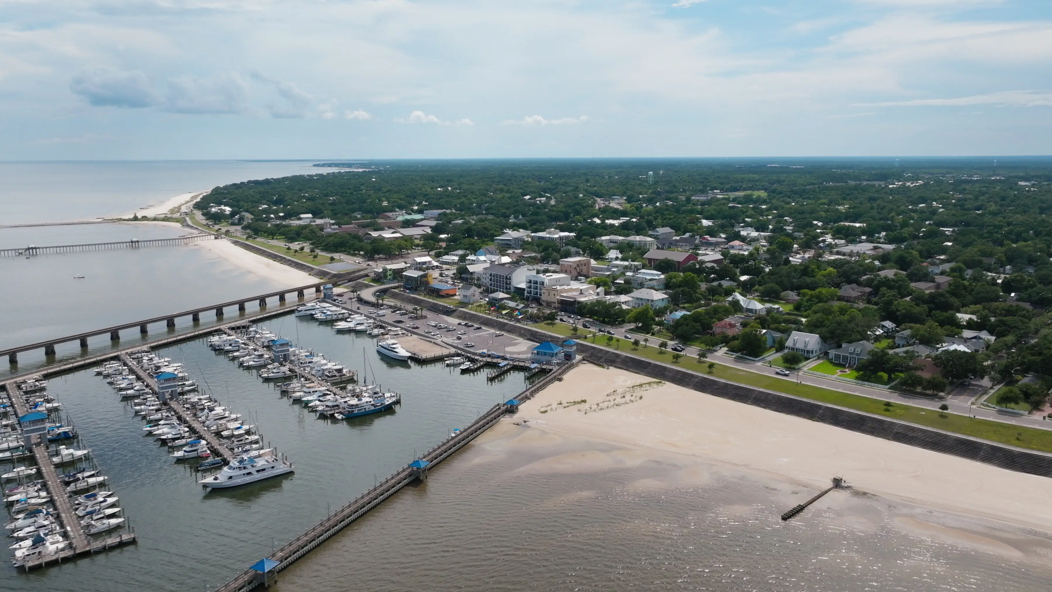 An aerial view of a marina, beach, and waterfront of Bay St. Louis, Mississippi.