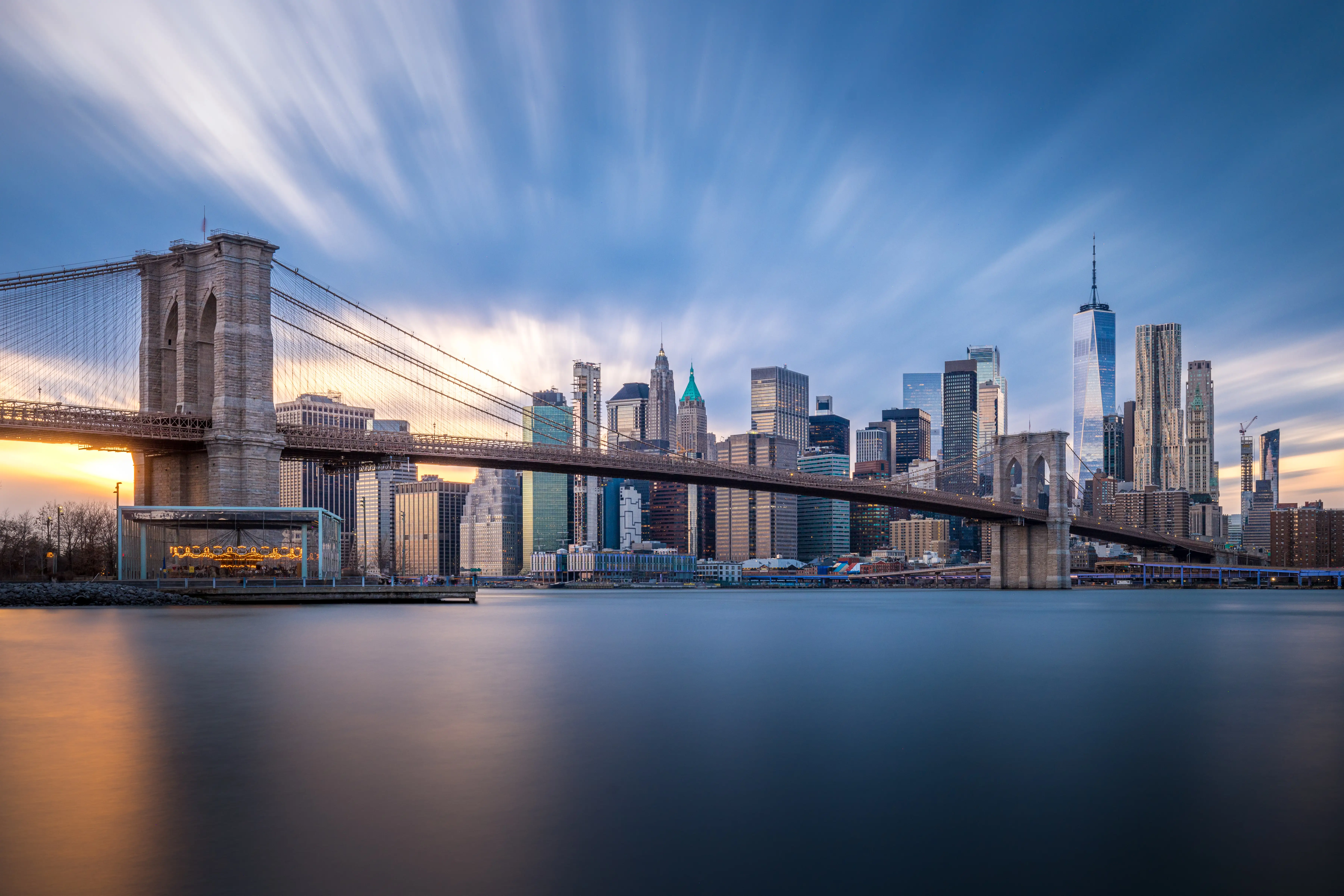 A daytime long exposure of the Brooklyn Bridge and Lower Manhattan.