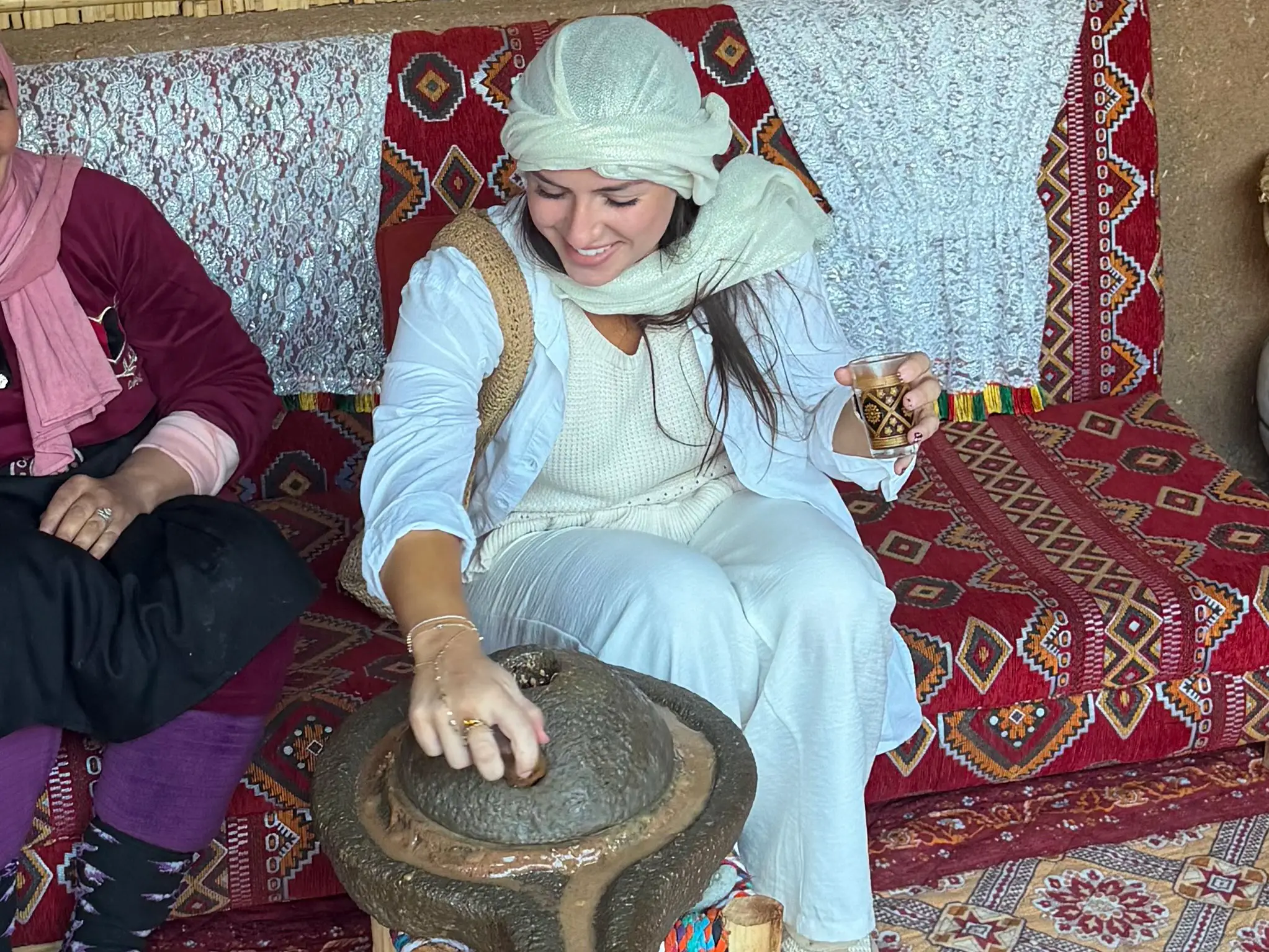 Amanda churns argan butter on an excursion in Morocco.