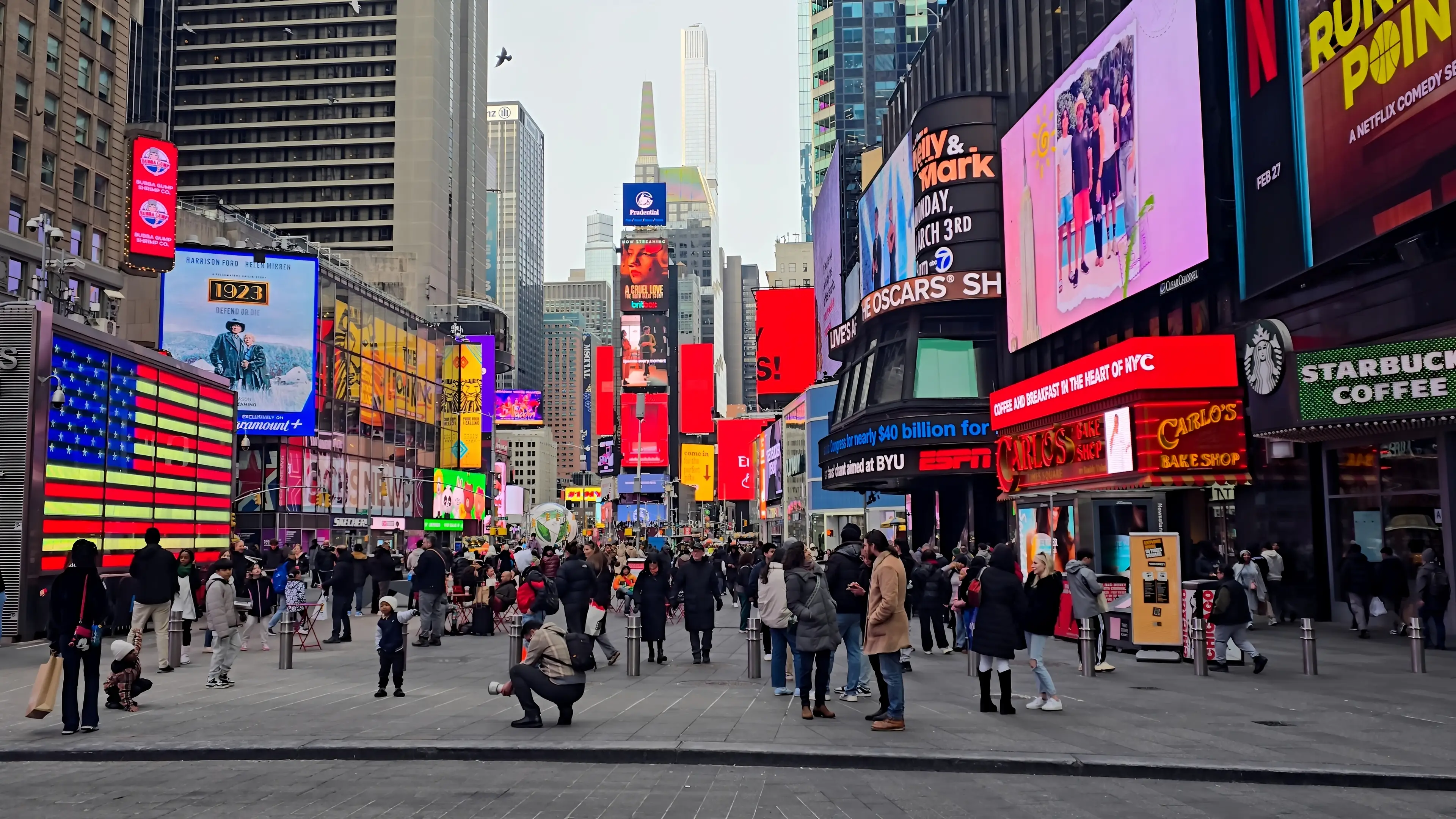 Crowds gather beneath billboards in Times Square in Manhattan