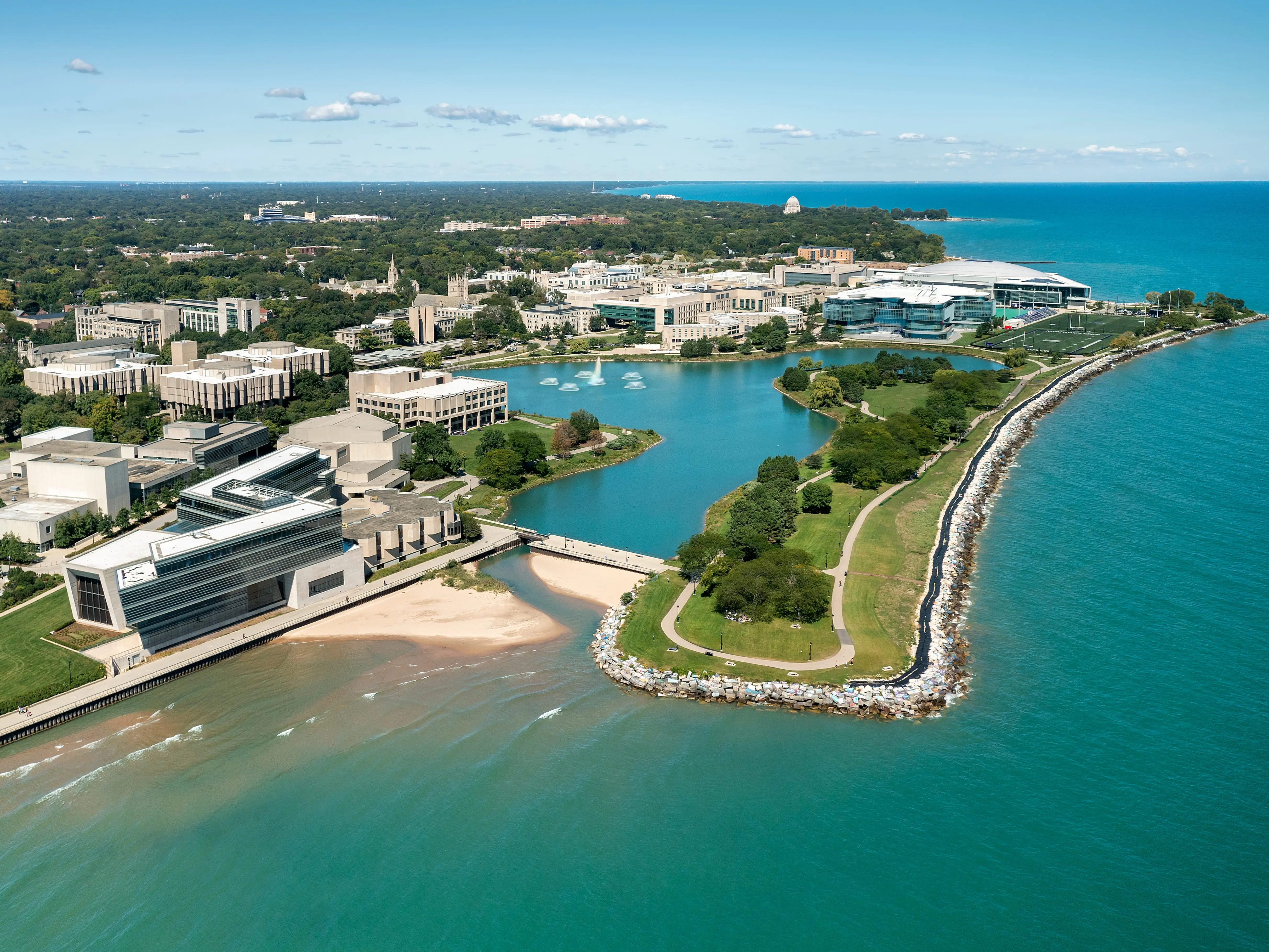 EVANSTON, IL — SEPTEMBER 9, 2021: Aerial view of Northwestern University and Lake Michigan with foreground beach and walking path.