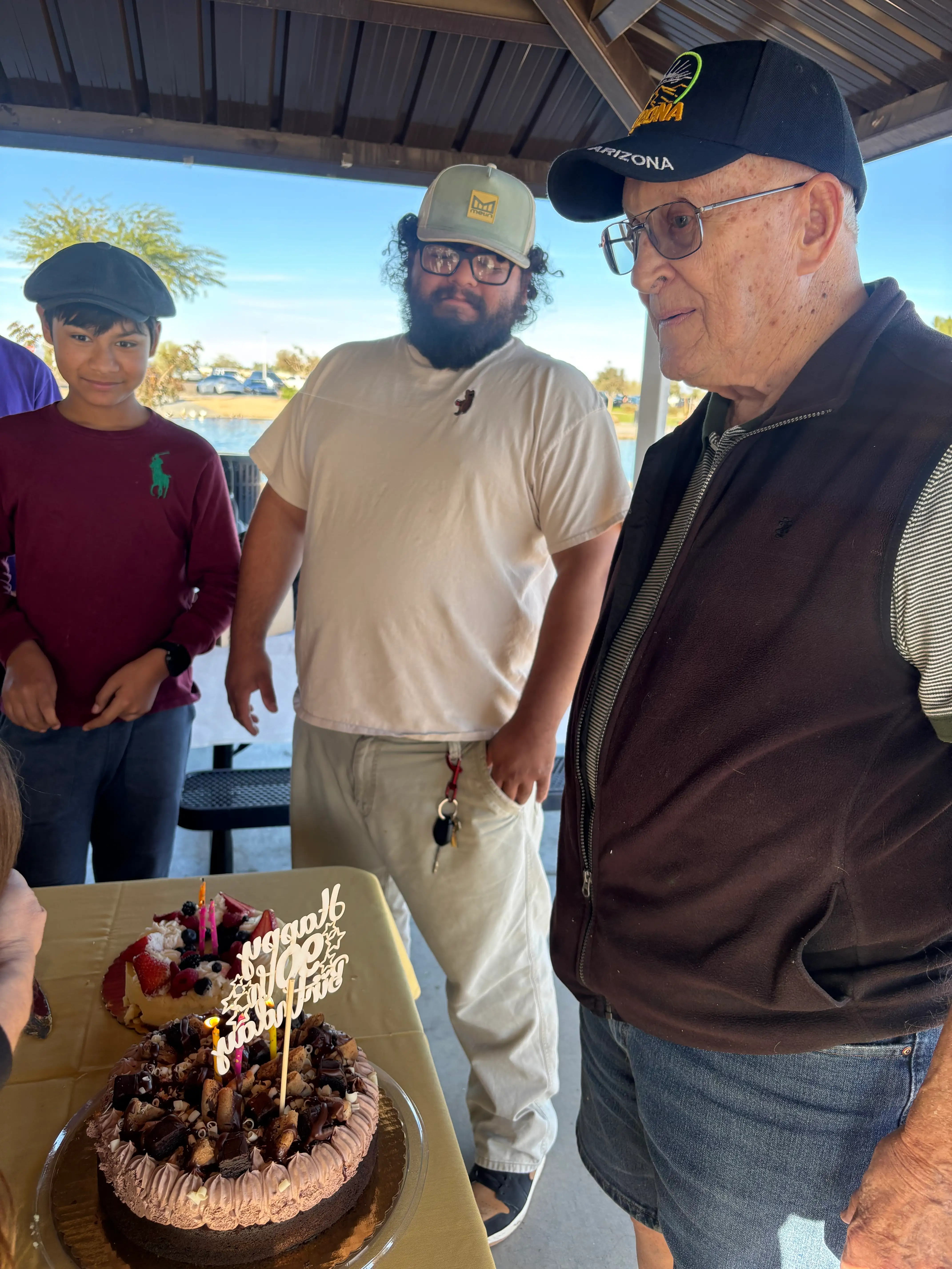 The author's grandpa celebrating his 90th birthday at the park with loved ones.