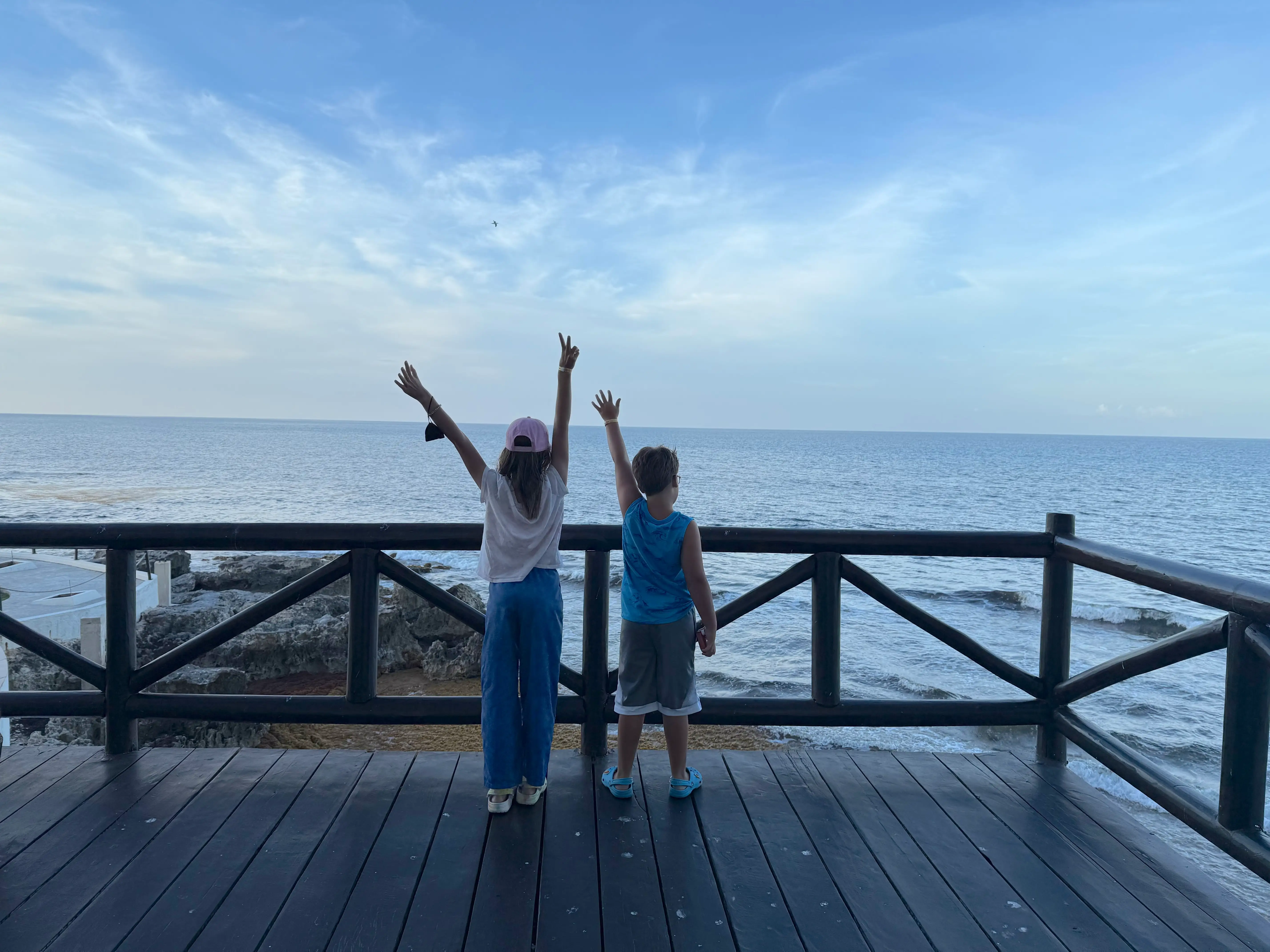 The author's kids standing on a dock overlooking water.
