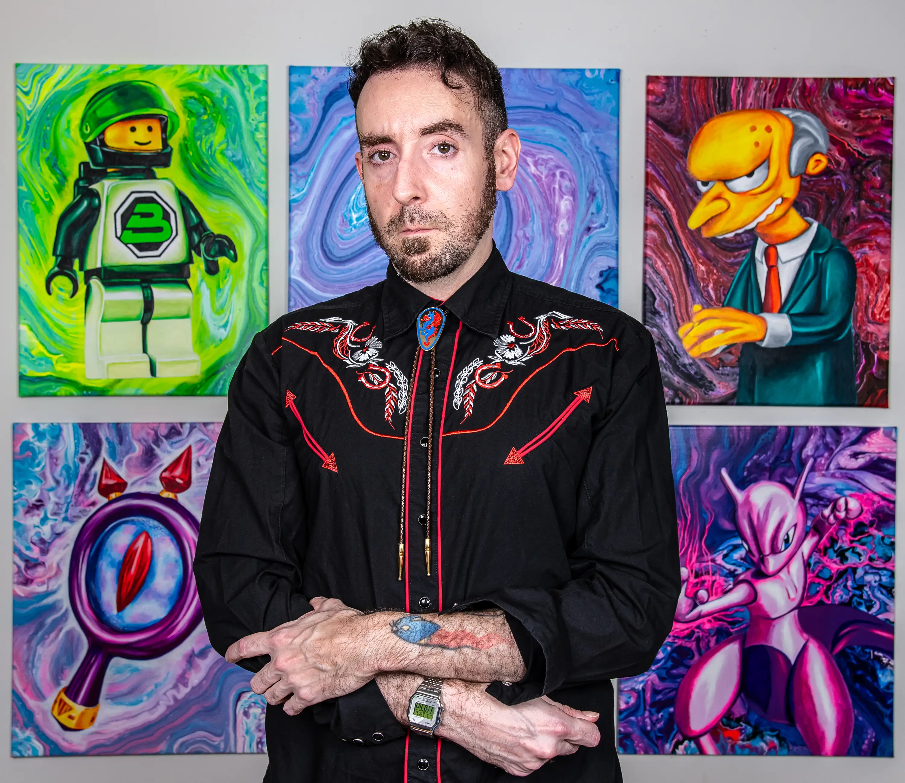 A man standing in front of artwork