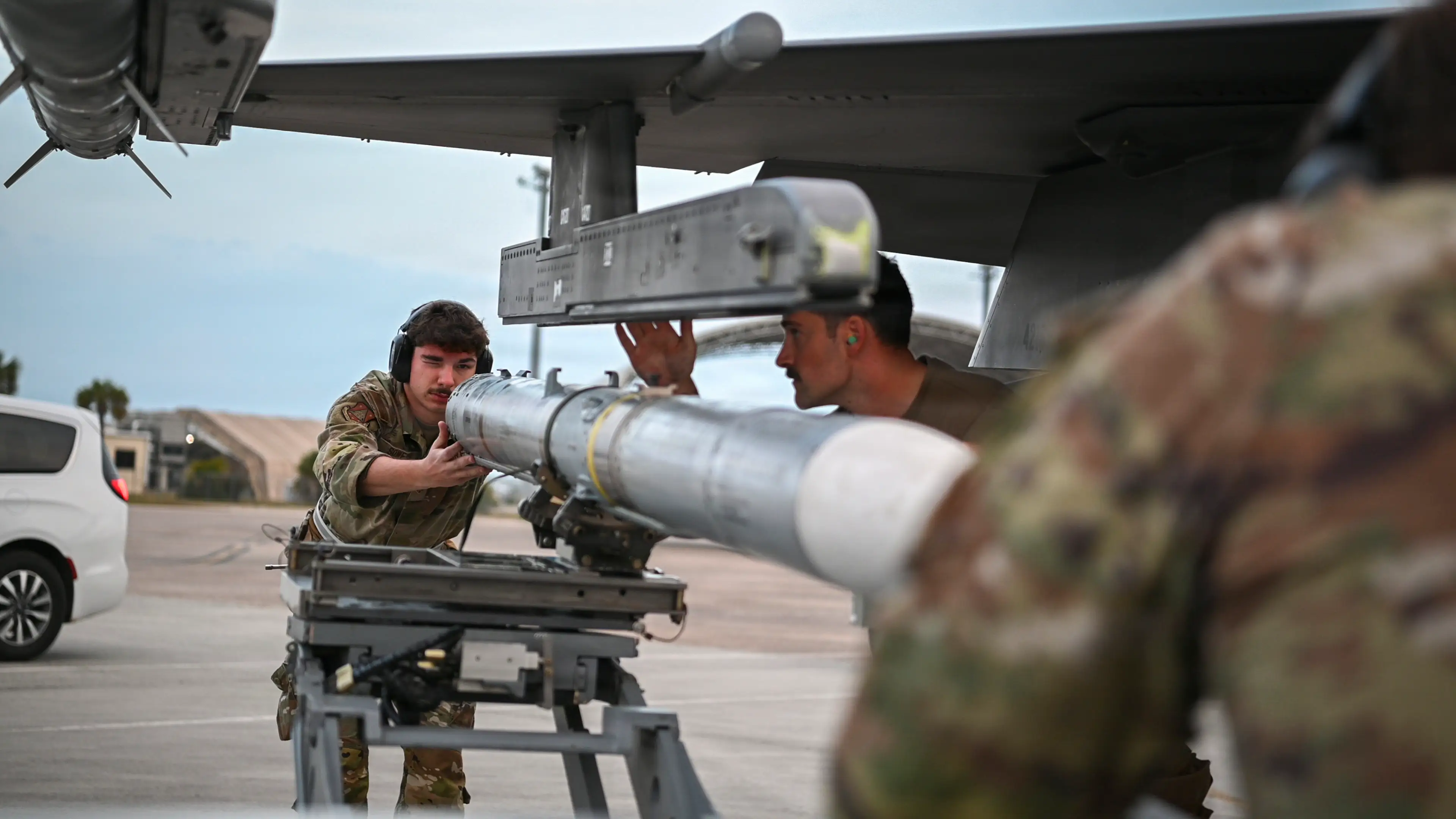 Air Force weapons specialists load missiles onto an F-16 during a training event in Florida, April 29, 2026.