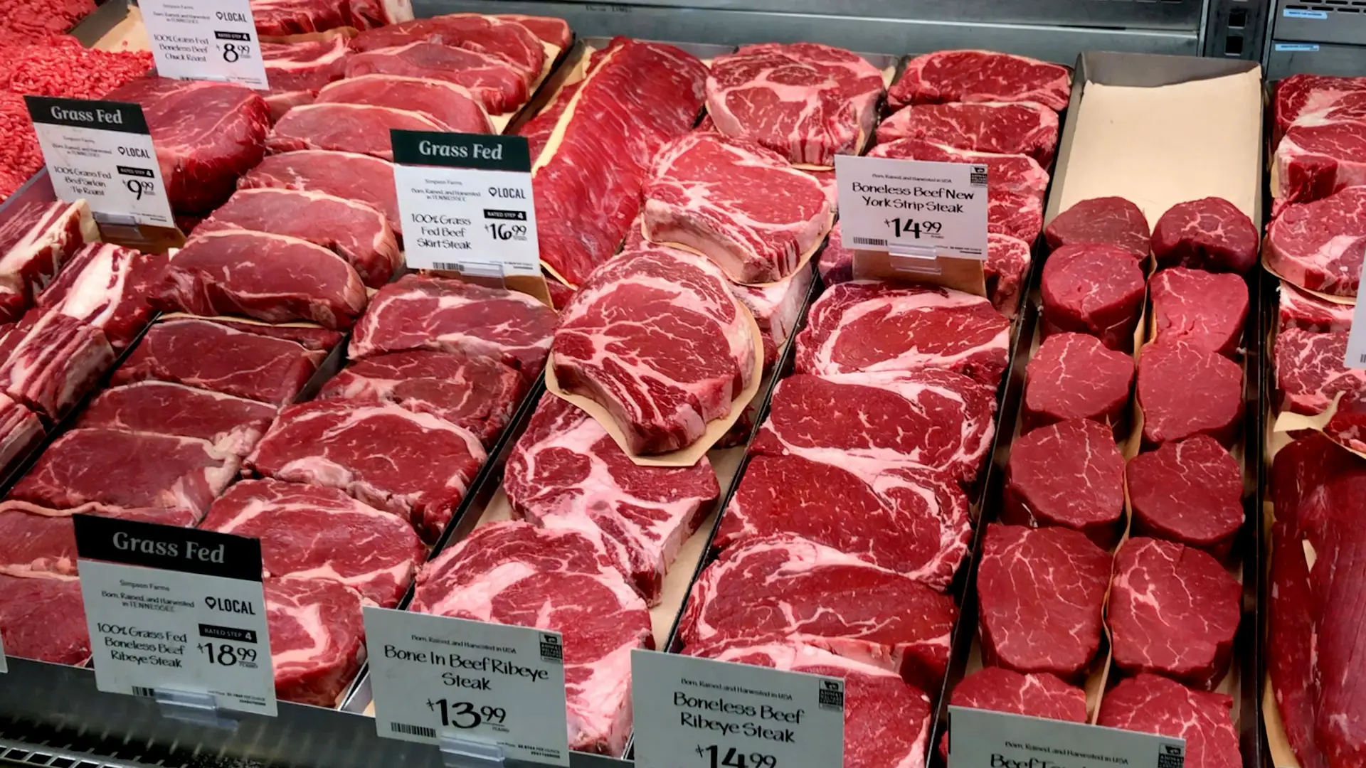 Steaks displayed at a grocery store with prices