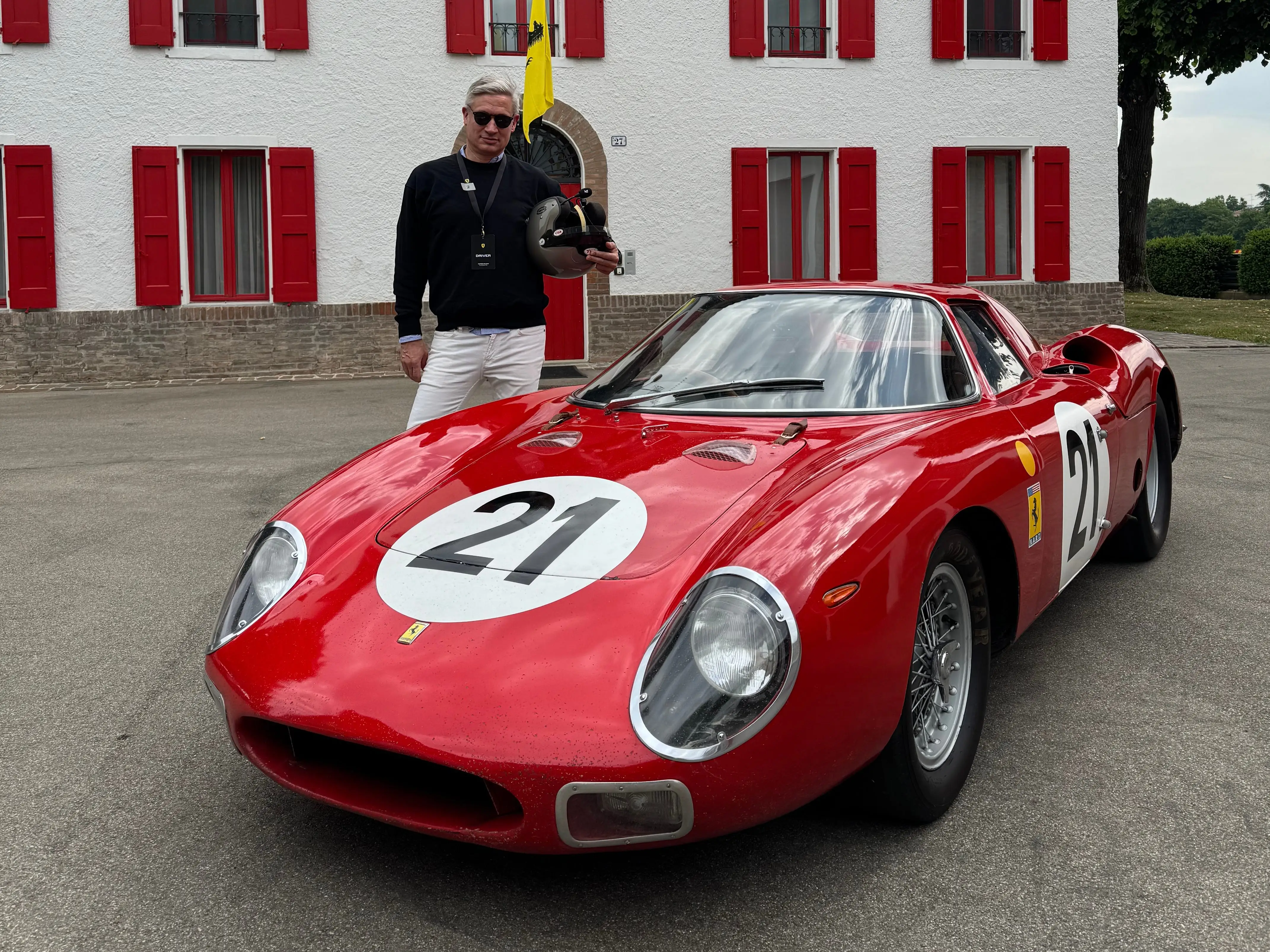 The author stands next to a classic Ferrari