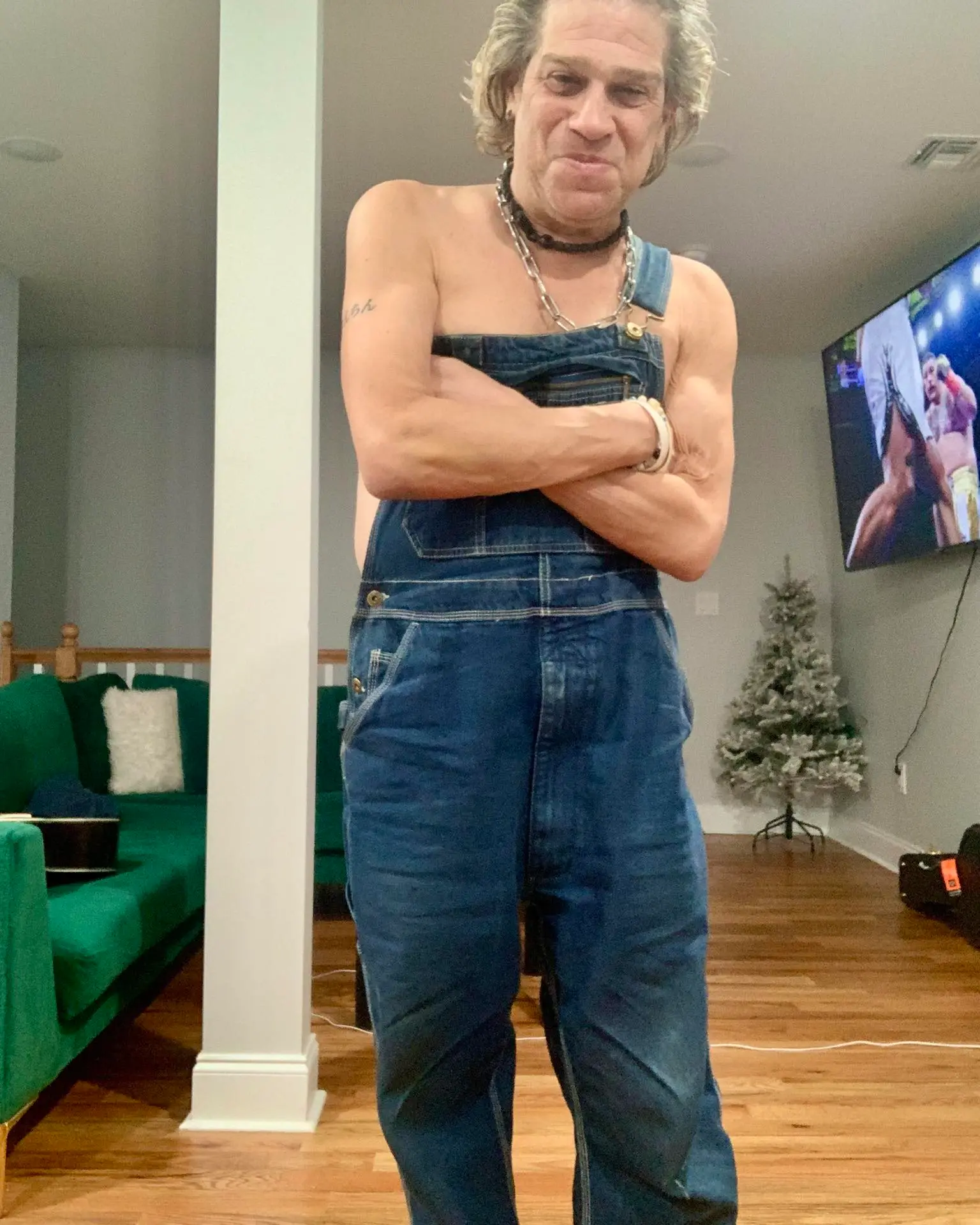 80s horror actor Jonathan Tiersten posing in overalls.