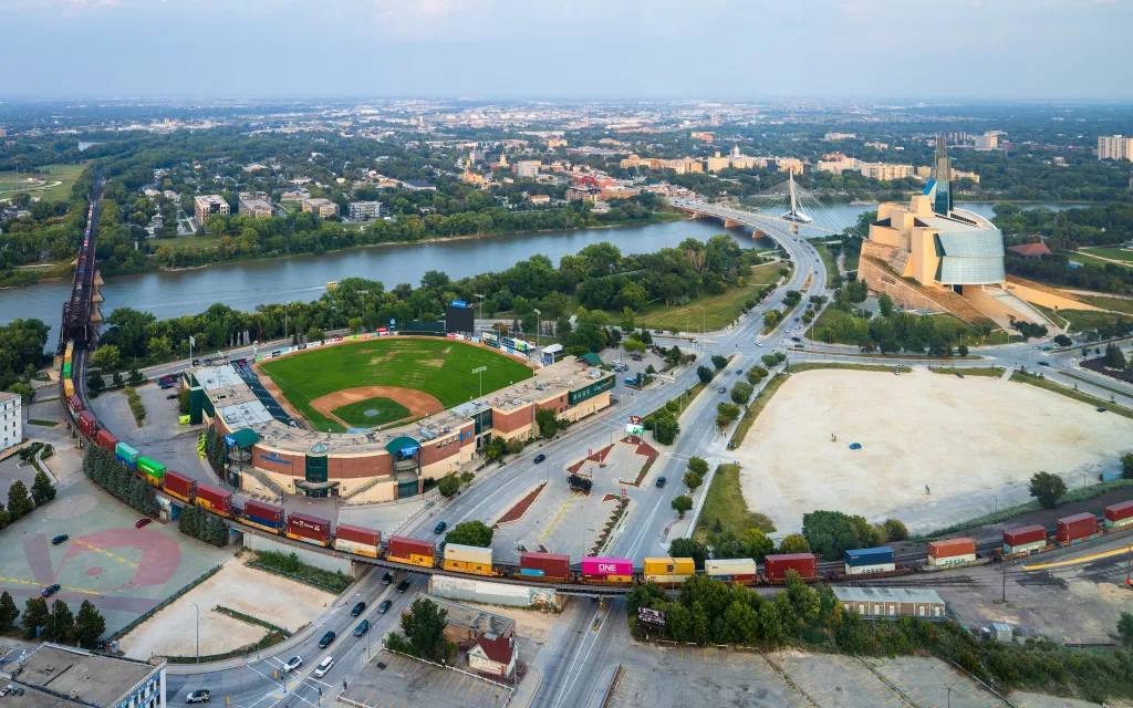 Aerial view of downtown Winnipeg, with the Canadian Museum for Human Rights, Provencher Bridge, Blue Cross Park, and the Red River.