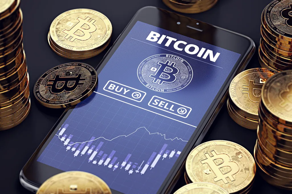 Illustration of a smartphone displaying a Bitcoin trading app with buy/sell options and a price chart, surrounded by stacks of golden Bitcoin coins.