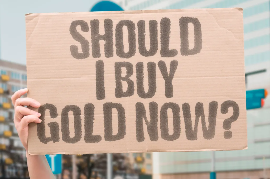 A person holding a cardboard sign that reads 