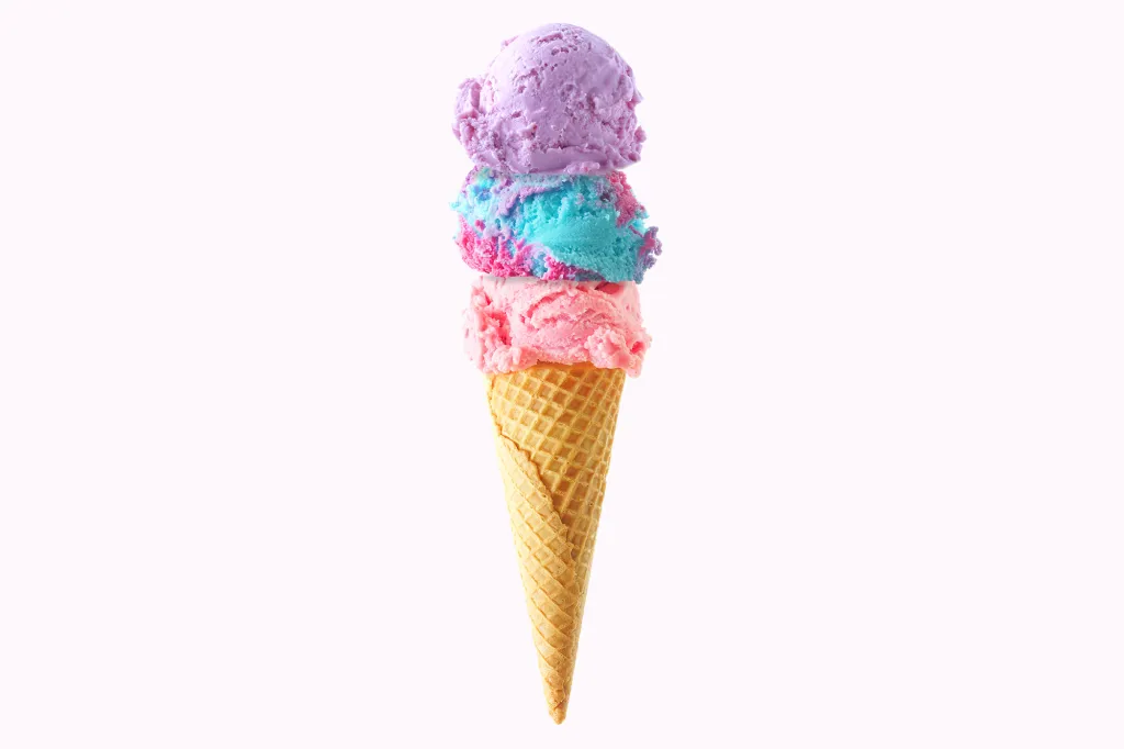 An ice cream cone with scoops of pink, blue, and purple ice cream.
