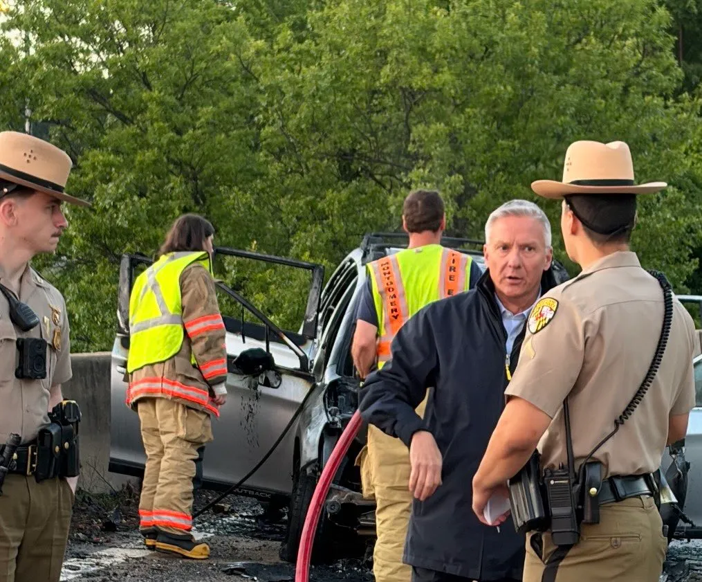 First responders at the scene of a burnt car accident.