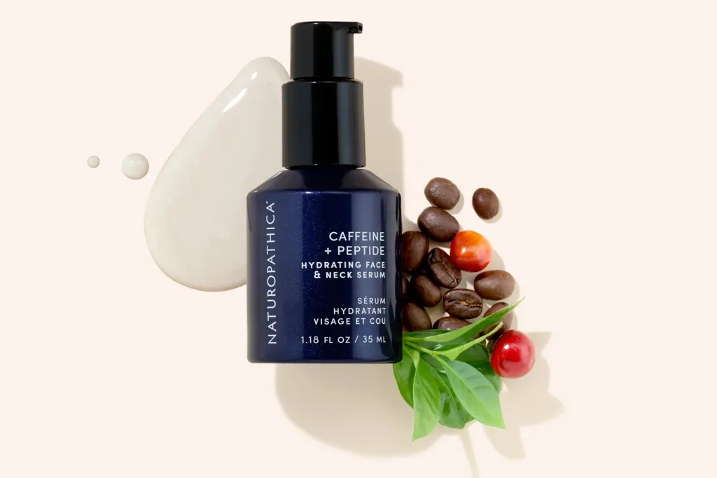 Naturopathica Caffeine + Peptide Hydrating Face & Neck Serum with coffee beans and leaves.