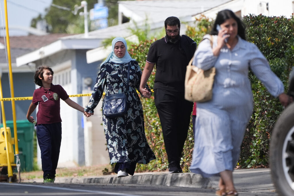 Slain mosque security guard had warned teachers to lock doors, imam says